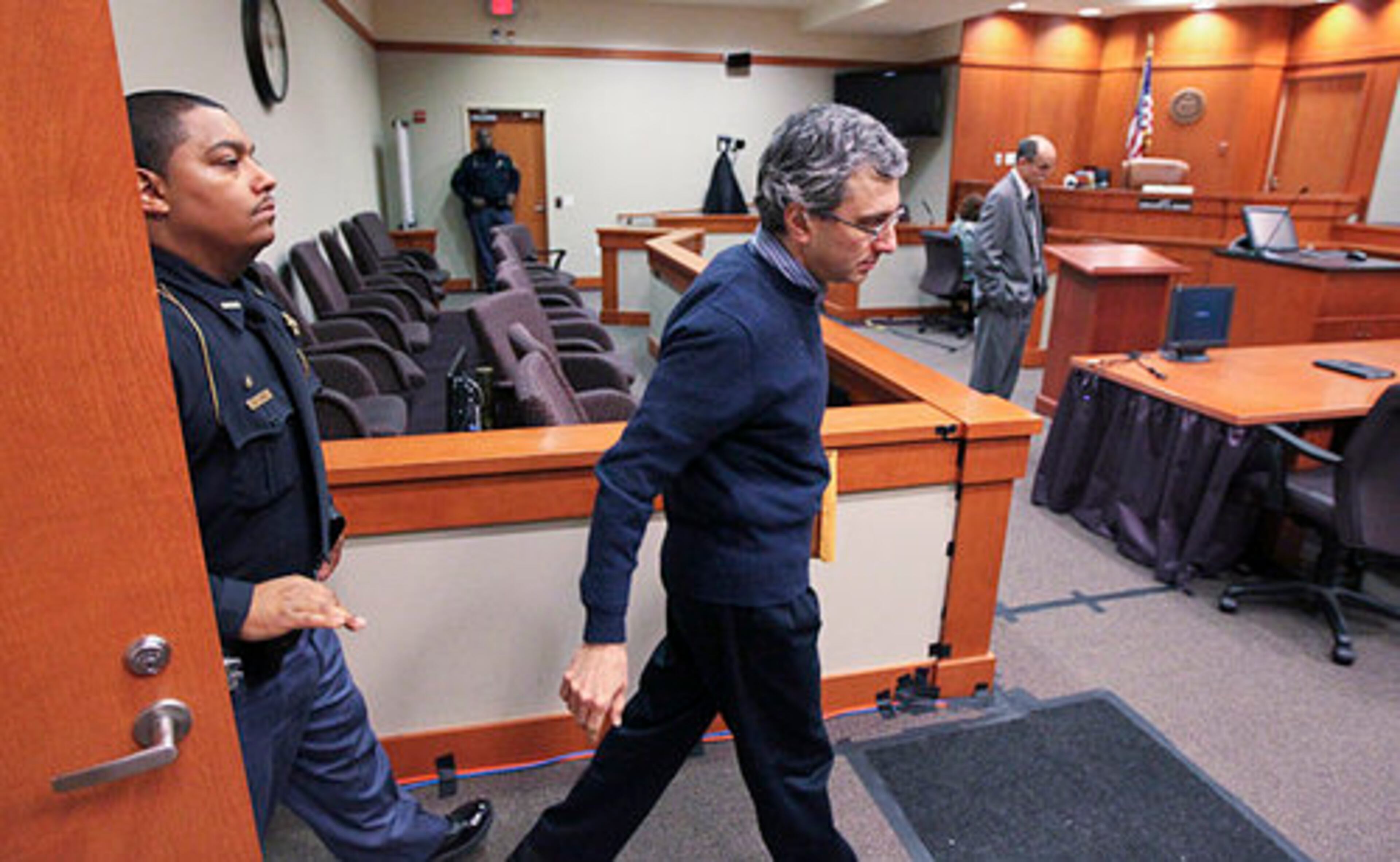 Hemy Neuman enters the courtroom after the jury posed a question Thursday, March 15, 2012 at the DeKalb County Courthouse in Decatur. Neuman is charged with the murder of Rusty Sneiderman at a Dunwoody daycare center in 2010.