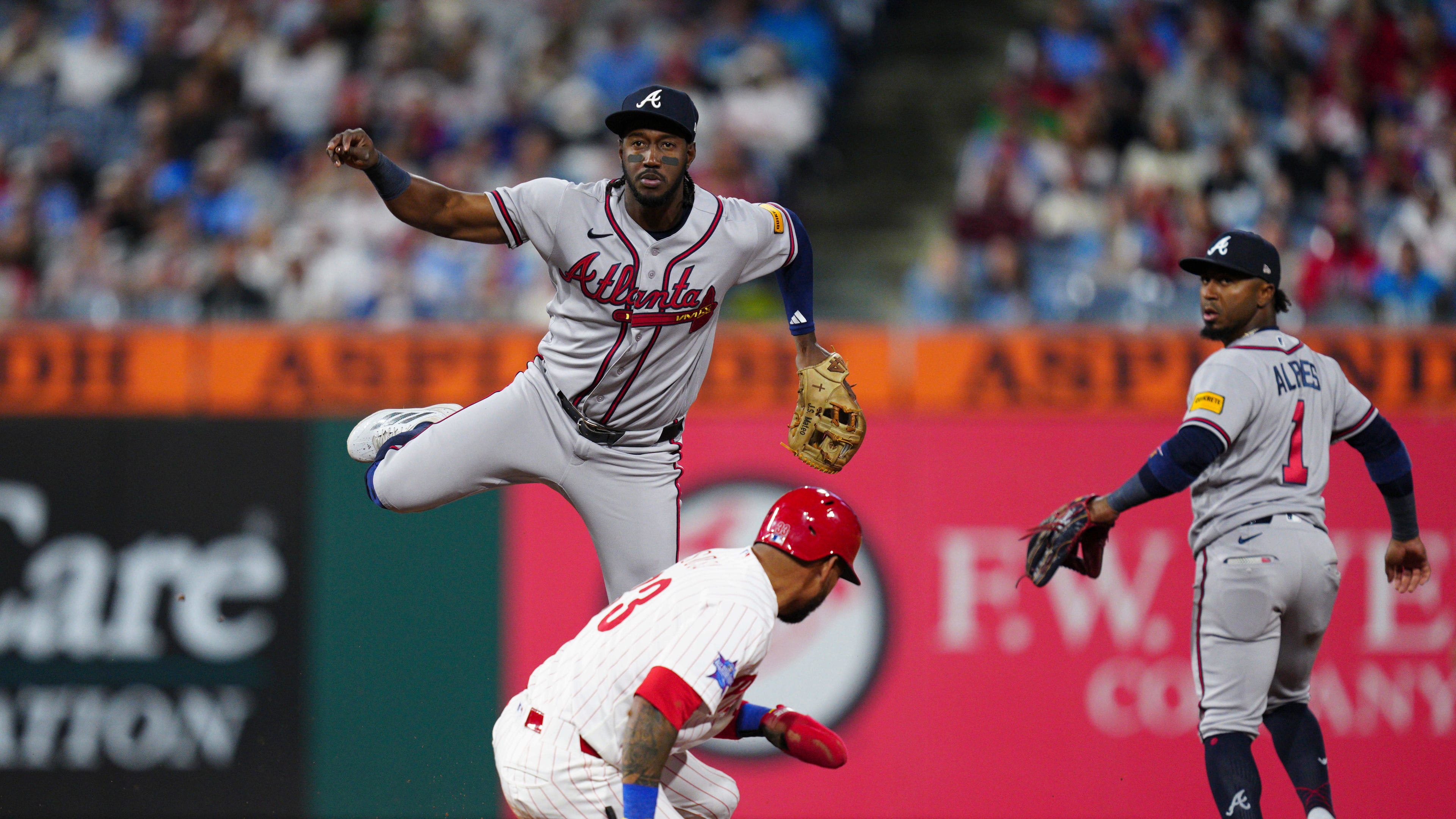 The Braves' Jorge Mateo (top center) throws to first base over Phillies' Edmundo Sosa to complete a double play during the fifth inning Saturday, April 18, 2026, in Philadelphia. Philadelphia's Brandon Marsh was out at first. (Derik Hamilton/AP)