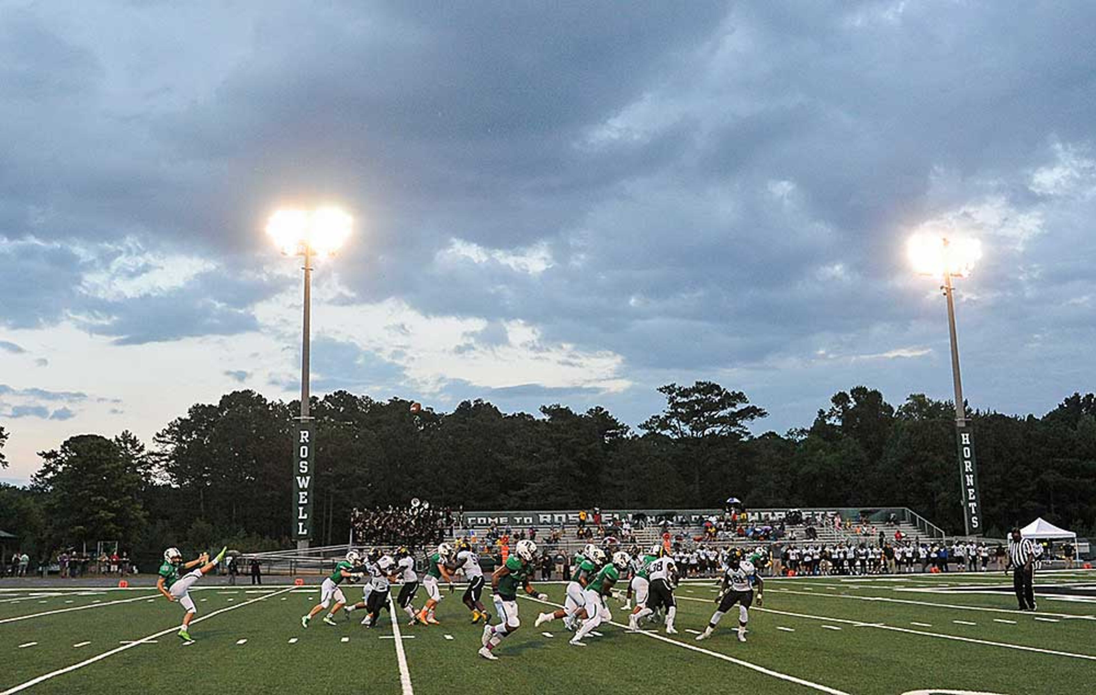Tropical depression Hermine provided only a cloudy backdrop for Roswell's Turner Barckhoff as he punts during the second quarter of Friday's game.