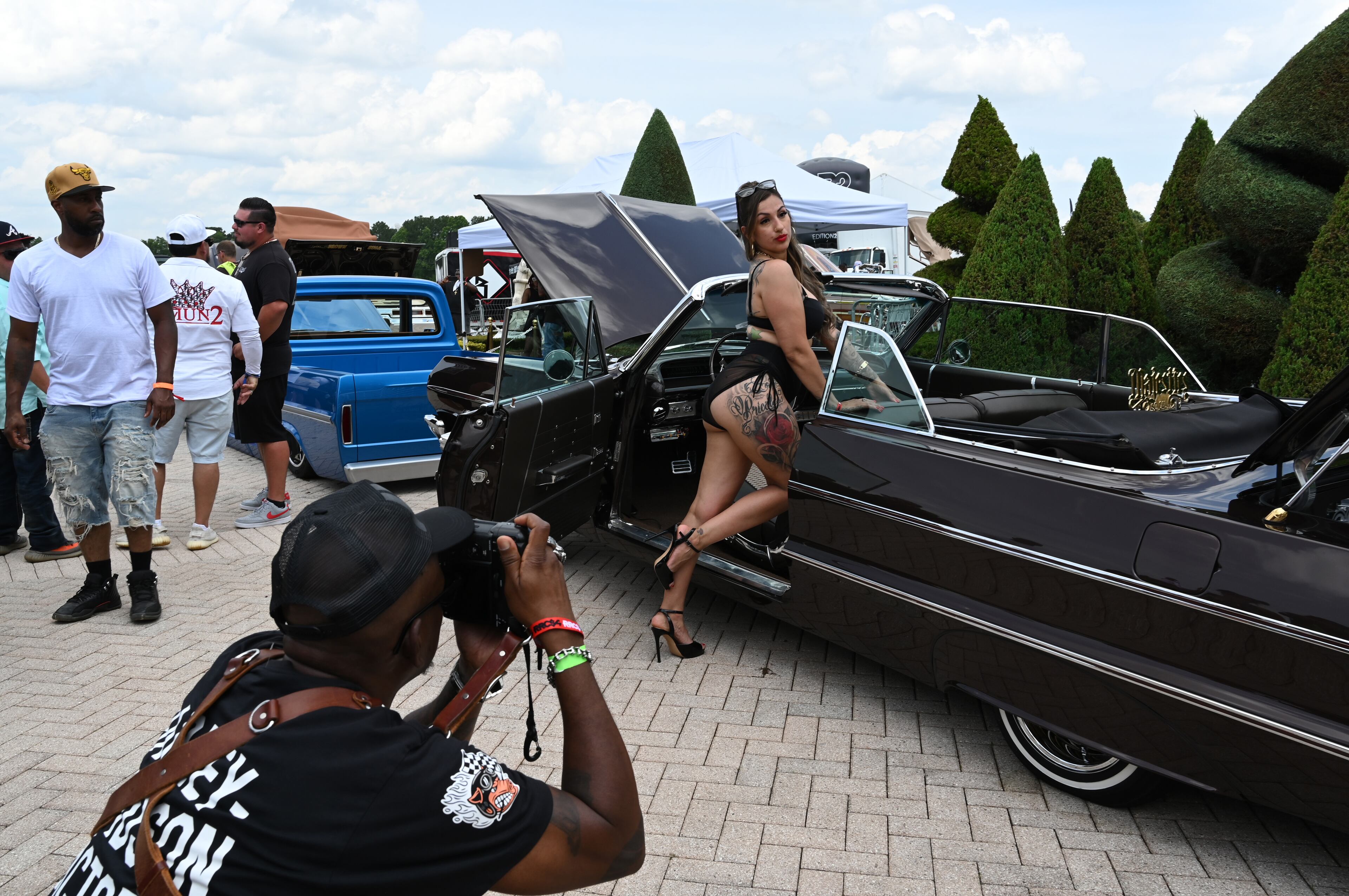 Attendees walk through fleets of classic/custom automobiles, luxury vehicles, boats, RVs and trailers on the front of the mansion during the 4th Annual Rick Ross Car and Bike Show, Saturday, June 7, 2025, in Fayetteville. The 4th Annual Rick Ross Car and Bike Show will include a vendor market with more than 30 vendors, food trucks, fleets of classic/custom automobiles, luxury vehicles, boats, RVs and trailers on the front of the mansion. Stage performances include Plies, Ross' new signee Nino Breeze and Ross himself. (Hyosub Shin / AJC)
