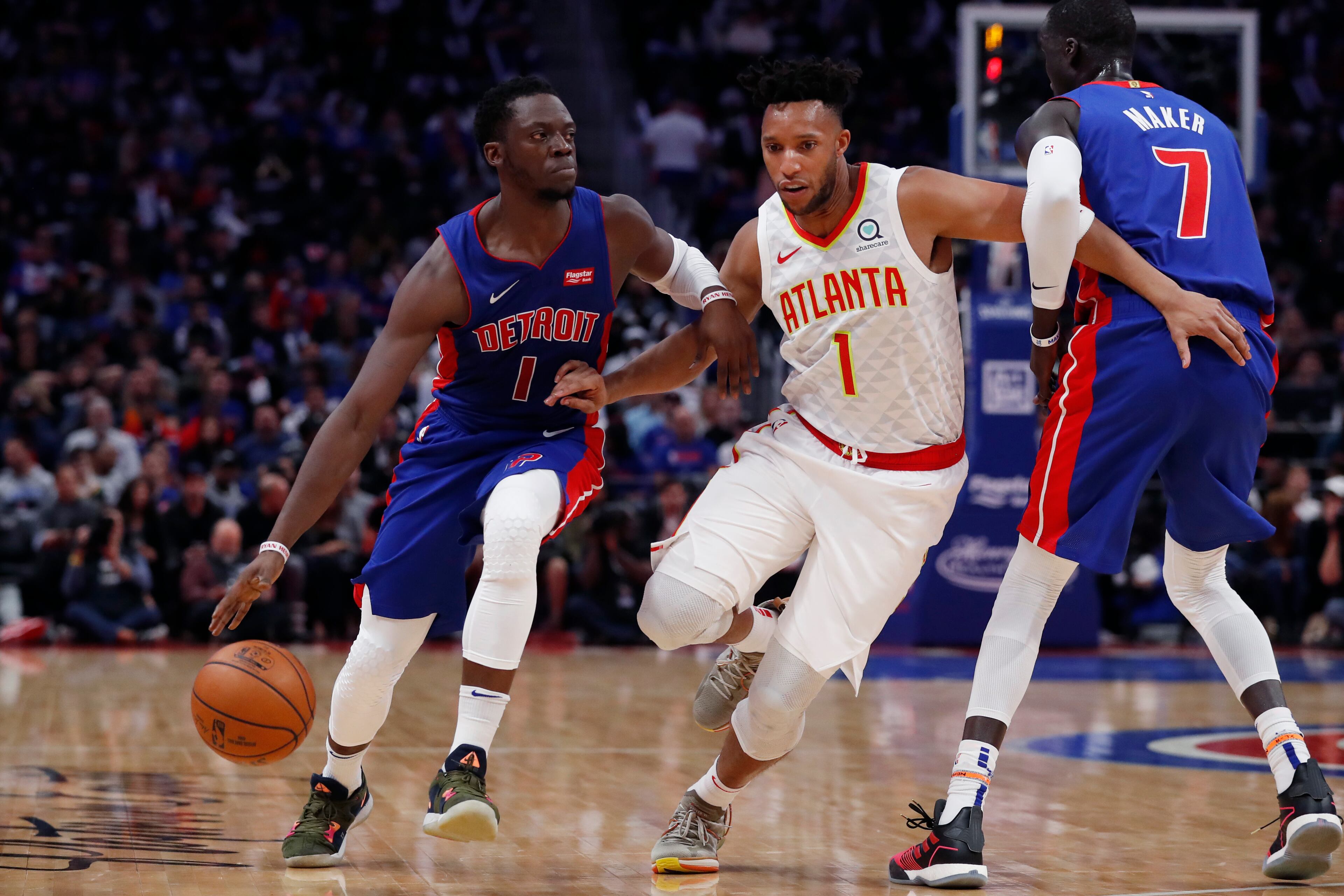 Detroit Pistons guard Reggie Jackson (1) drives as Atlanta Hawks guard Evan Turner (1) defends during the first half of an NBA basketball game Thursday, Oct. 24, 2019, in Detroit. (AP Photo/Carlos Osorio)