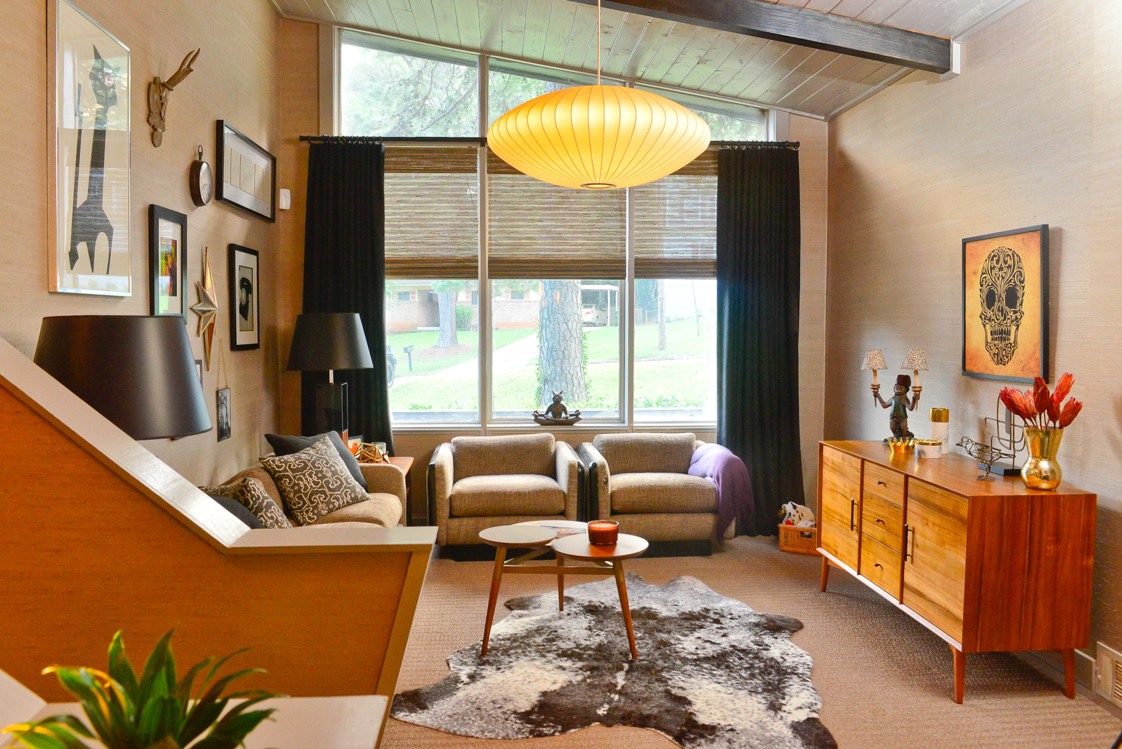 Vaulted ceilings with wood beams and grasscloth wallcoverings are among some of the favorite design elements in the East Lake home. For the walls, the owners like picking up items from World Market, IKEA, Ballard Designs and various artists who show at The Highlander in Atlanta.