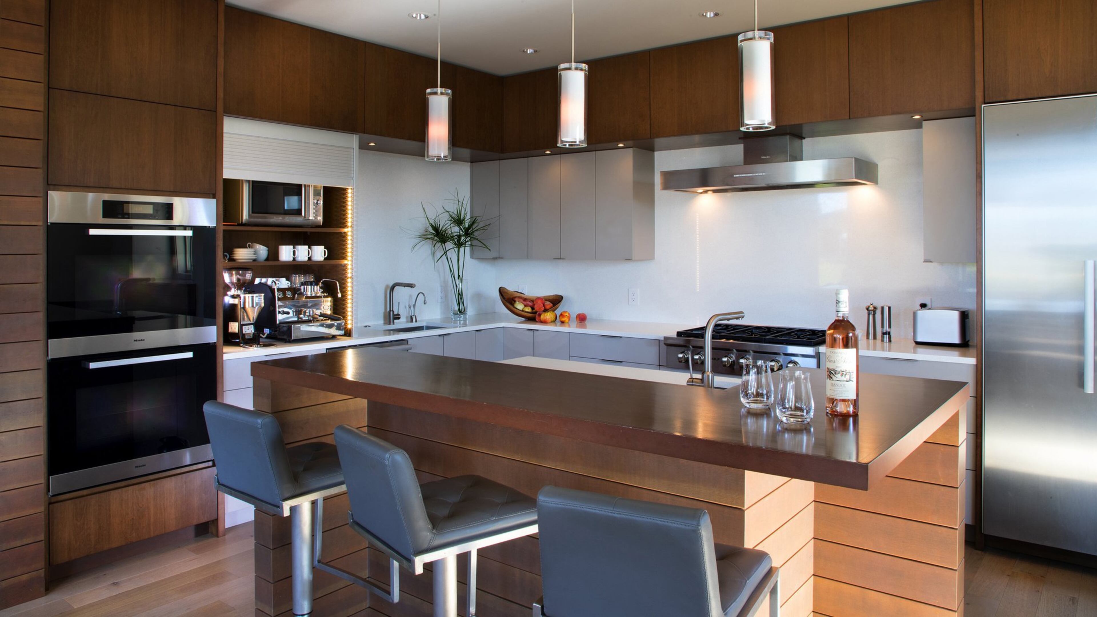 Trace and Reid s shiny new kitchen switched locales with the dining area. The gray cabinets are sturdy and easy to clean, Trace says, and their serious coffee maker parks in an appliance garage to the left. I have a problem with clutter on the countertops, says interior designer Hilary Young. They can make it a showpiece when they want to, and close it off otherwise, like a little jewelbox. (Mike Siegel/Seattle Times/TNS)