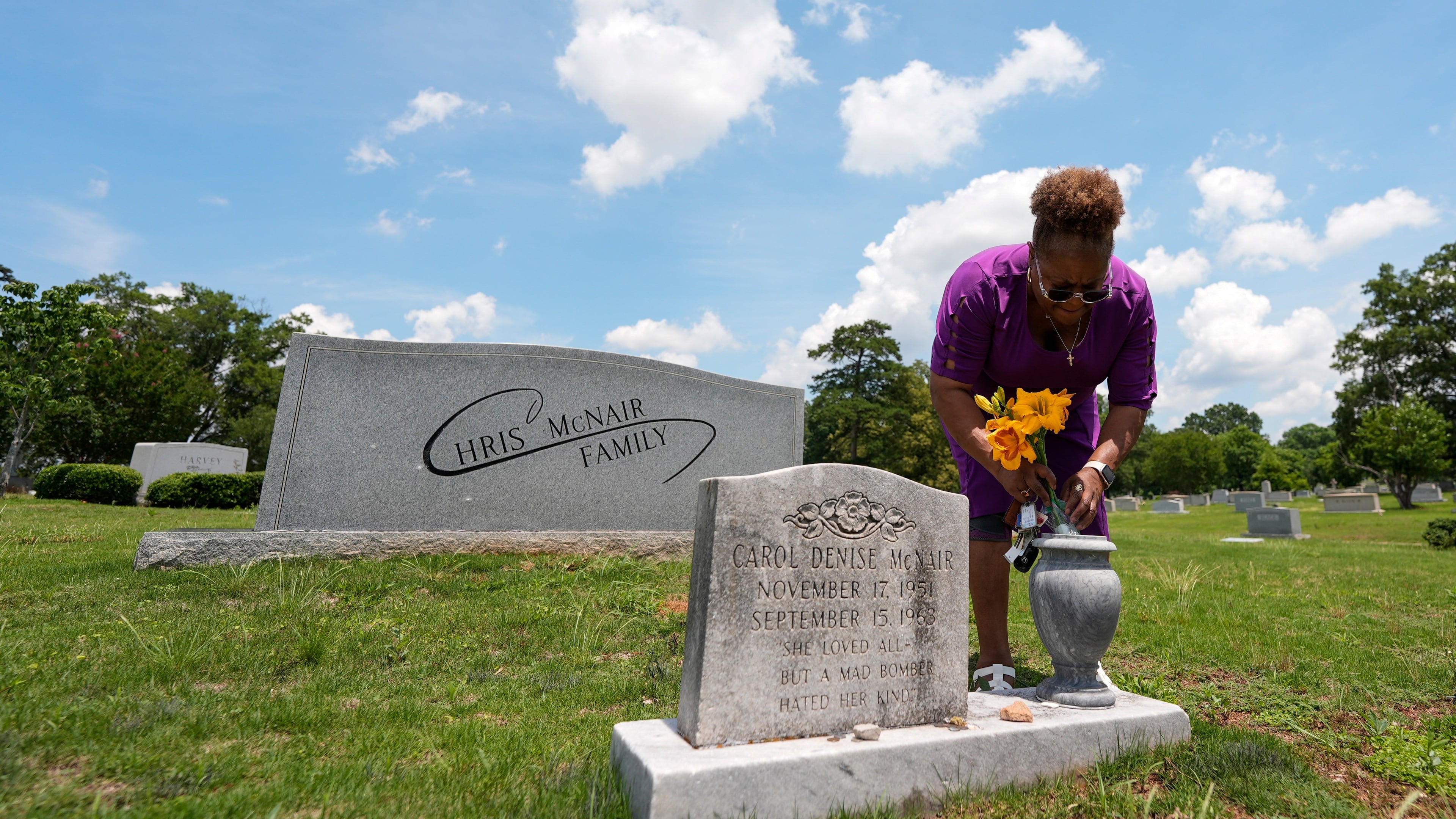 Lisa McNair arranges flowers on the grave of her late sister, Carol Denise McNair, Monday, June 1, 2026, in Birmingham, Ala. (AP Photo/Mike Stewart)