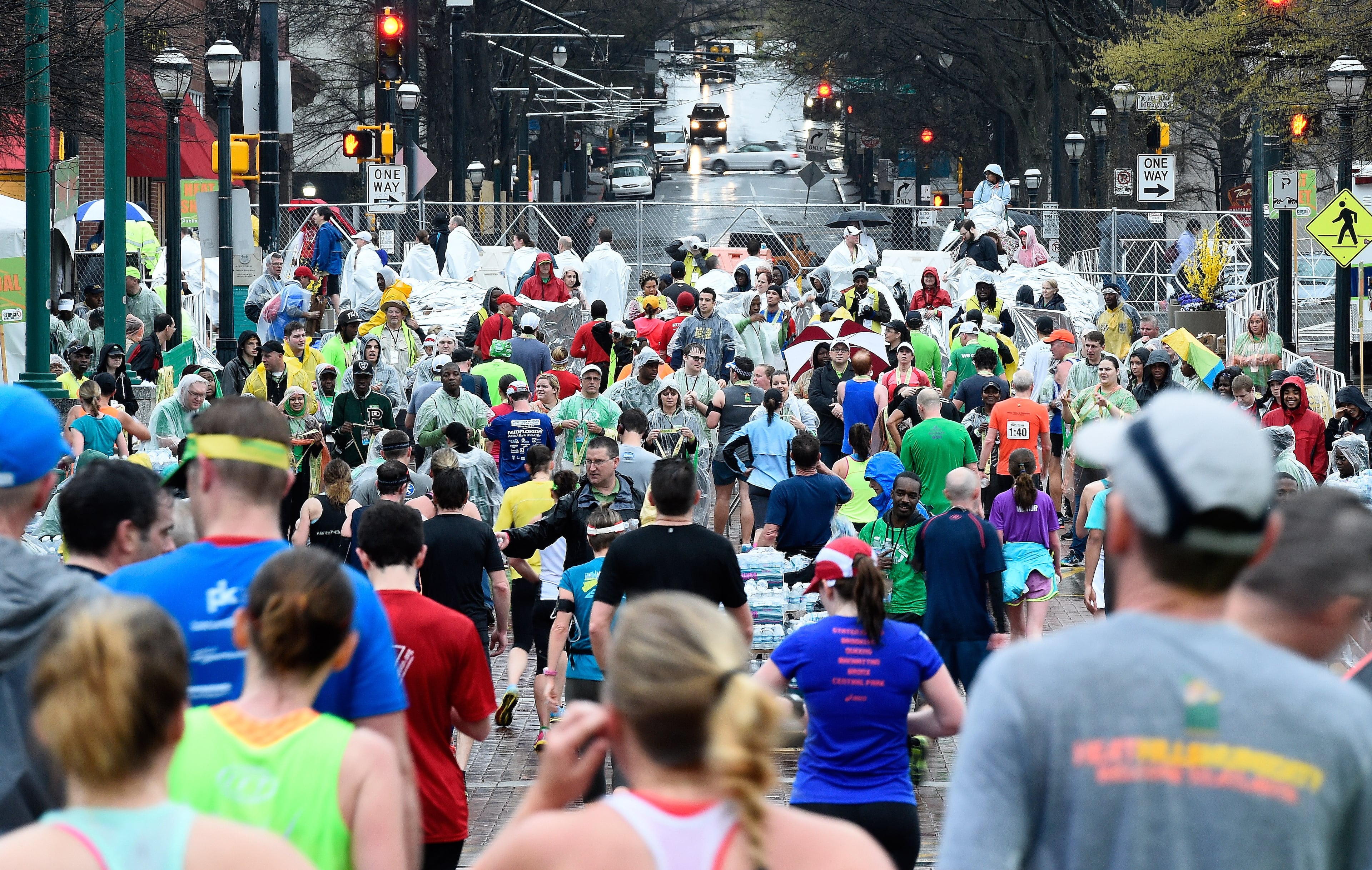 Despite a steady rain, runners from 46 states and 22 countries participate in the Publix Georgia Marathon & Half Marathon, Luckie 5K and Wheelchair Half Marathon on Sunday, March 22, 2015, in Atlanta. David Tulis / AJC Special