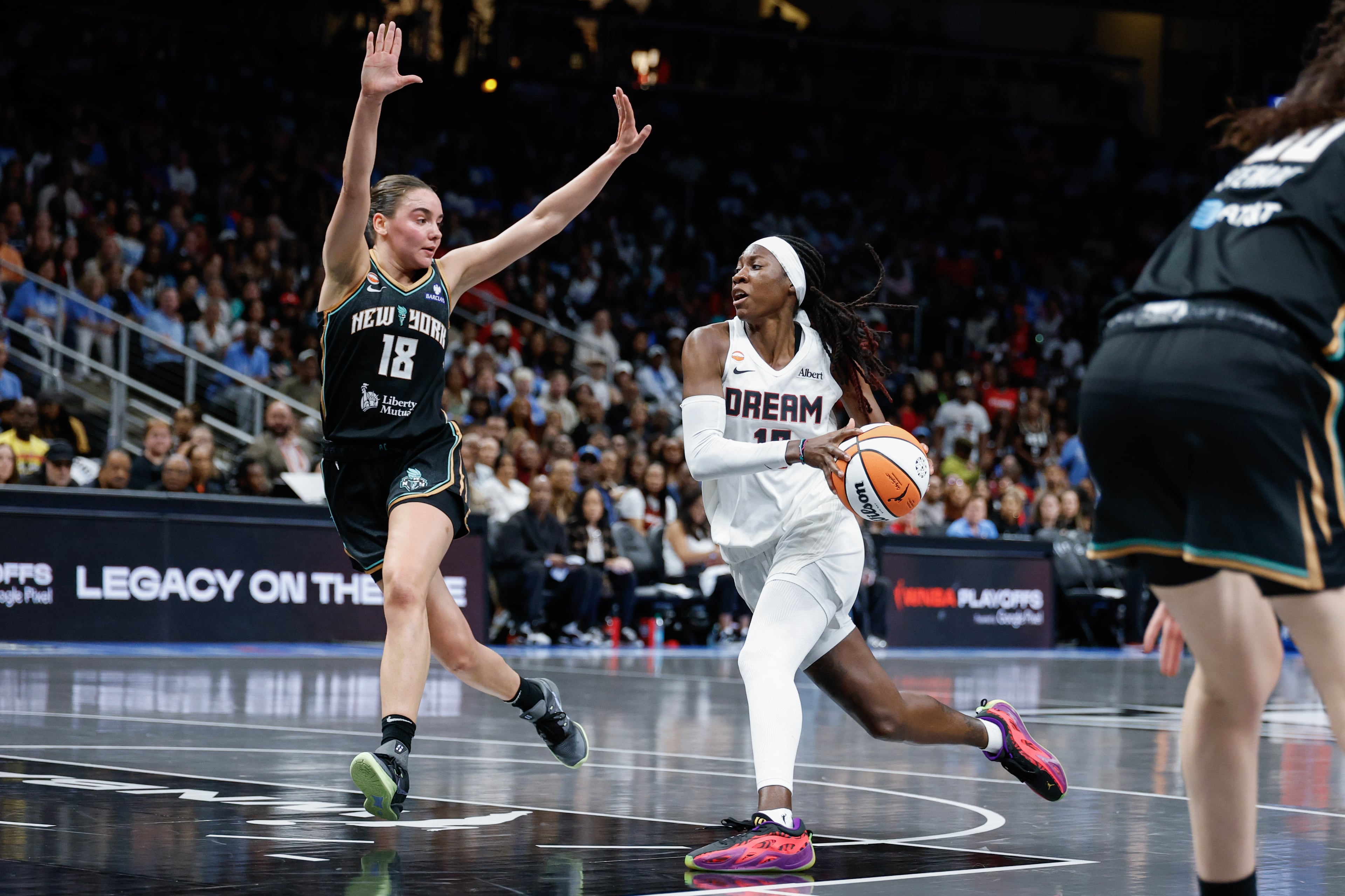 Atlanta Dream guard Rhyne Howard, right, drives against New York Liberty guard Pauline Astier (18) during the first half of a WNBA semifinal playoff game 1 between the Atlanta Dream and the New York Liberty, Sunday, Oct. 4, 2026, in Atlanta. (Erik S. Lesser for the AJC)