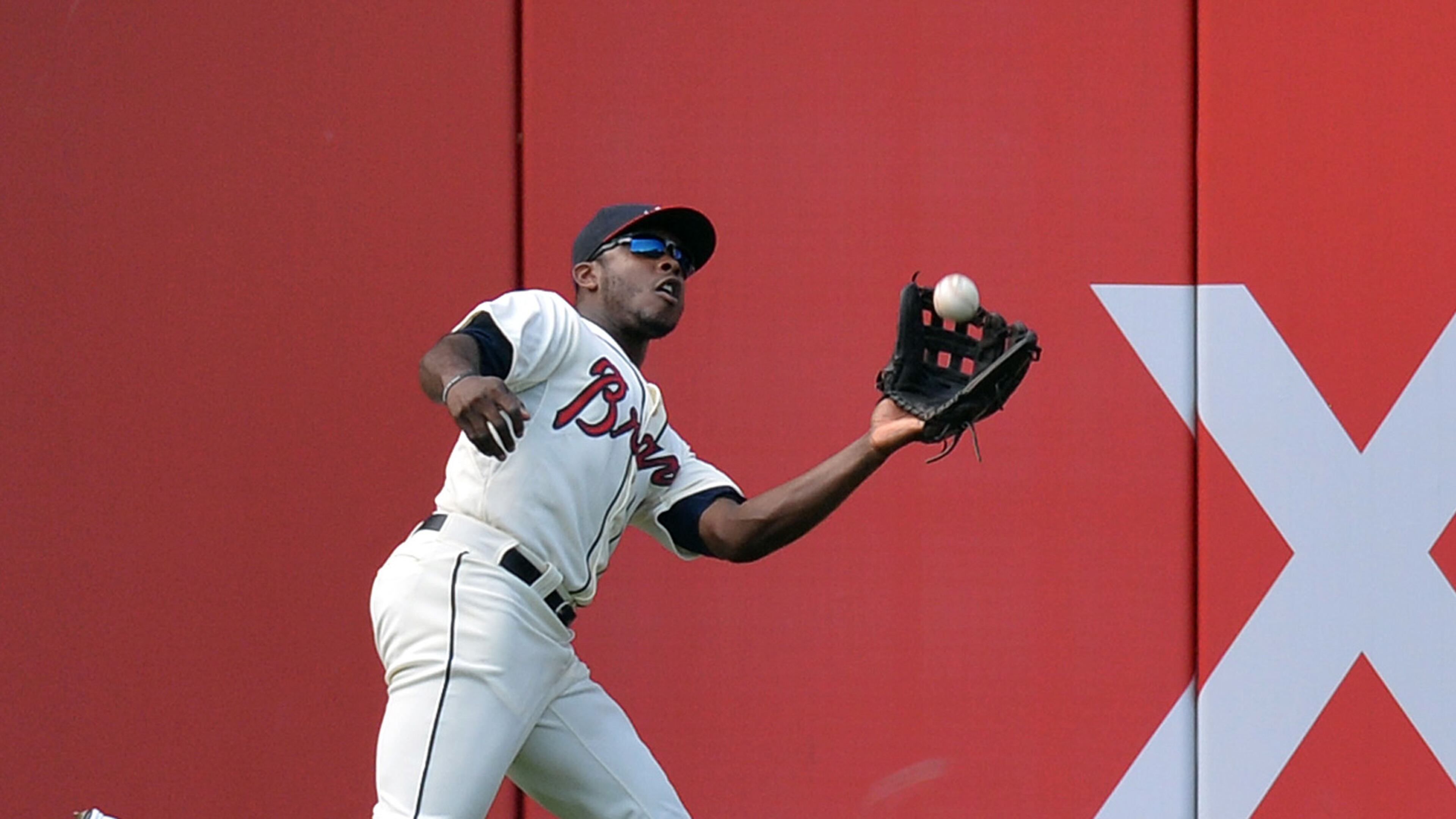 Braves left fielder Justin Upton (8) catches a fly ball hit by San Francisco Giants third baseman Joaquin Arias (13) in the 3rd inning at Turner Field in Atlanta on Saturday, June 15, 2013.