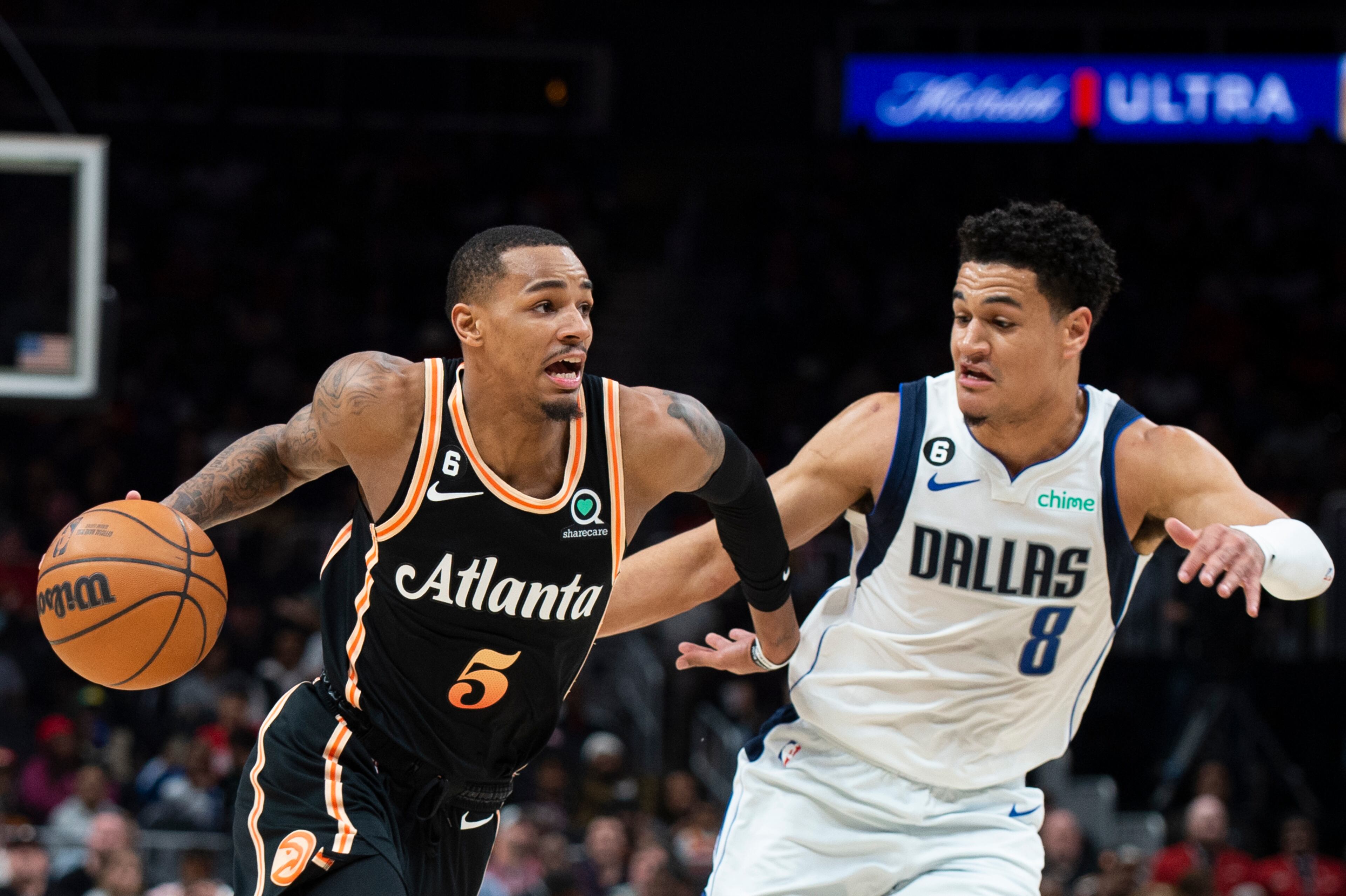 Hawks guard Dejounte Murray drives to the basket against Dallas Mavericks guard Josh Green during the first half of an NBA basketball game, Sunday, April 2, 2023, in Atlanta.