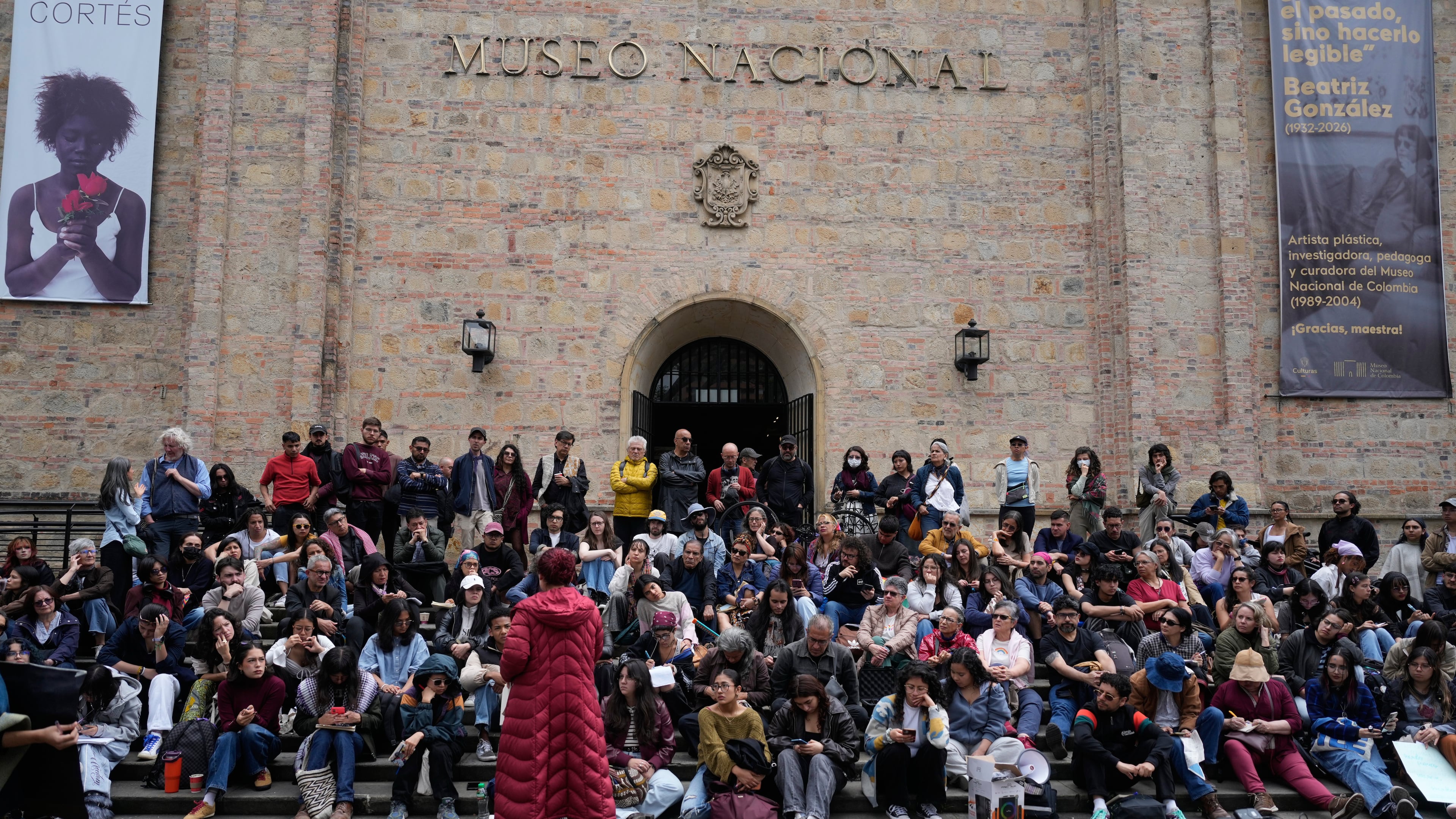 University students hold a class outdoors in front of the National Museum as part of a protest against the removal of some artworks from the museum in Bogota, Colombia, Wednesday, Oct. 21, 2026. (AP Photo/Fernando Vergara)