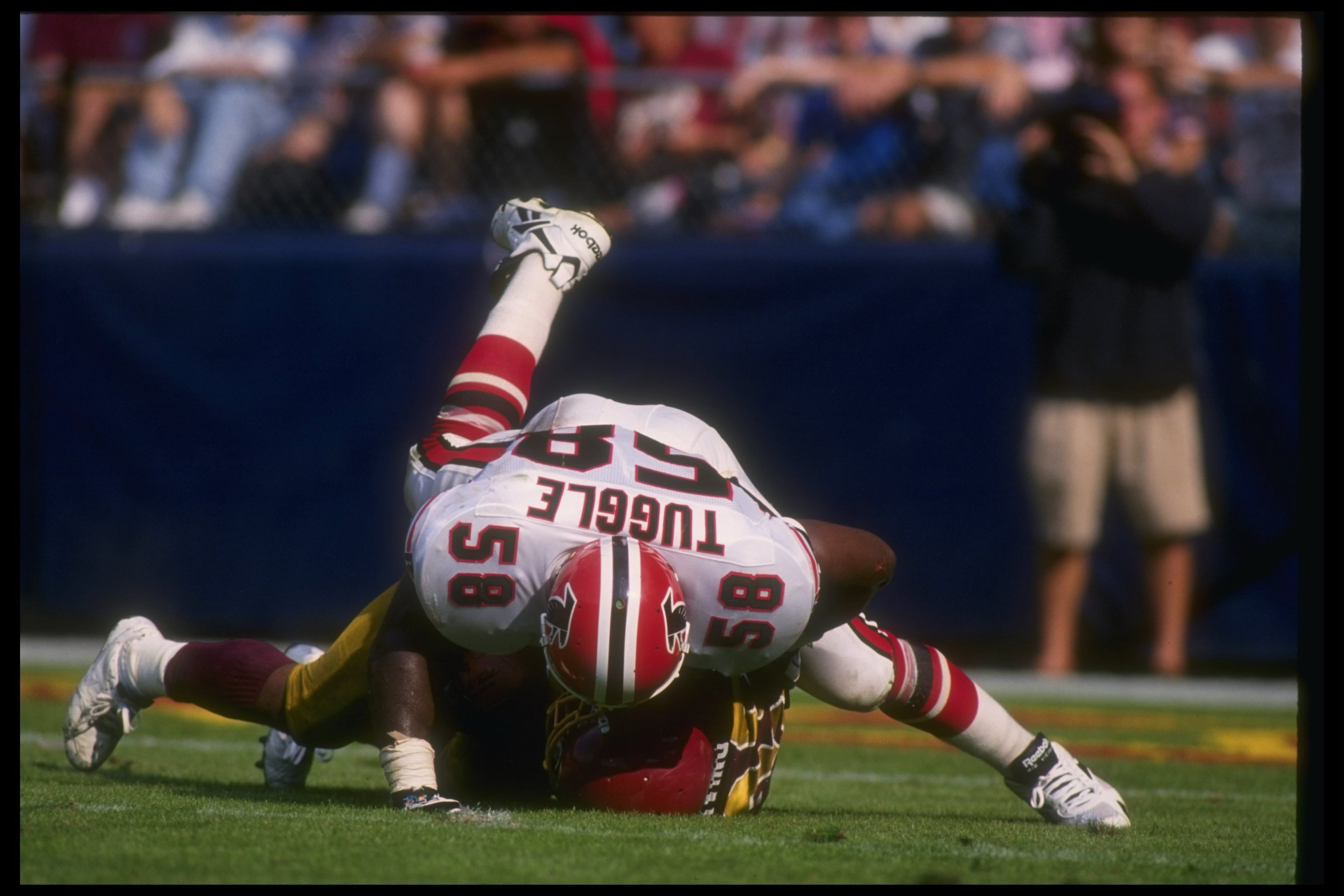 Linebacker Jessie Tuggle of the Falcons tackles a Redskins player Sept. 25, 1994 during a game at RFK Stadium in Washington. Mandatory Credit: Doug Pensinger/Allsport