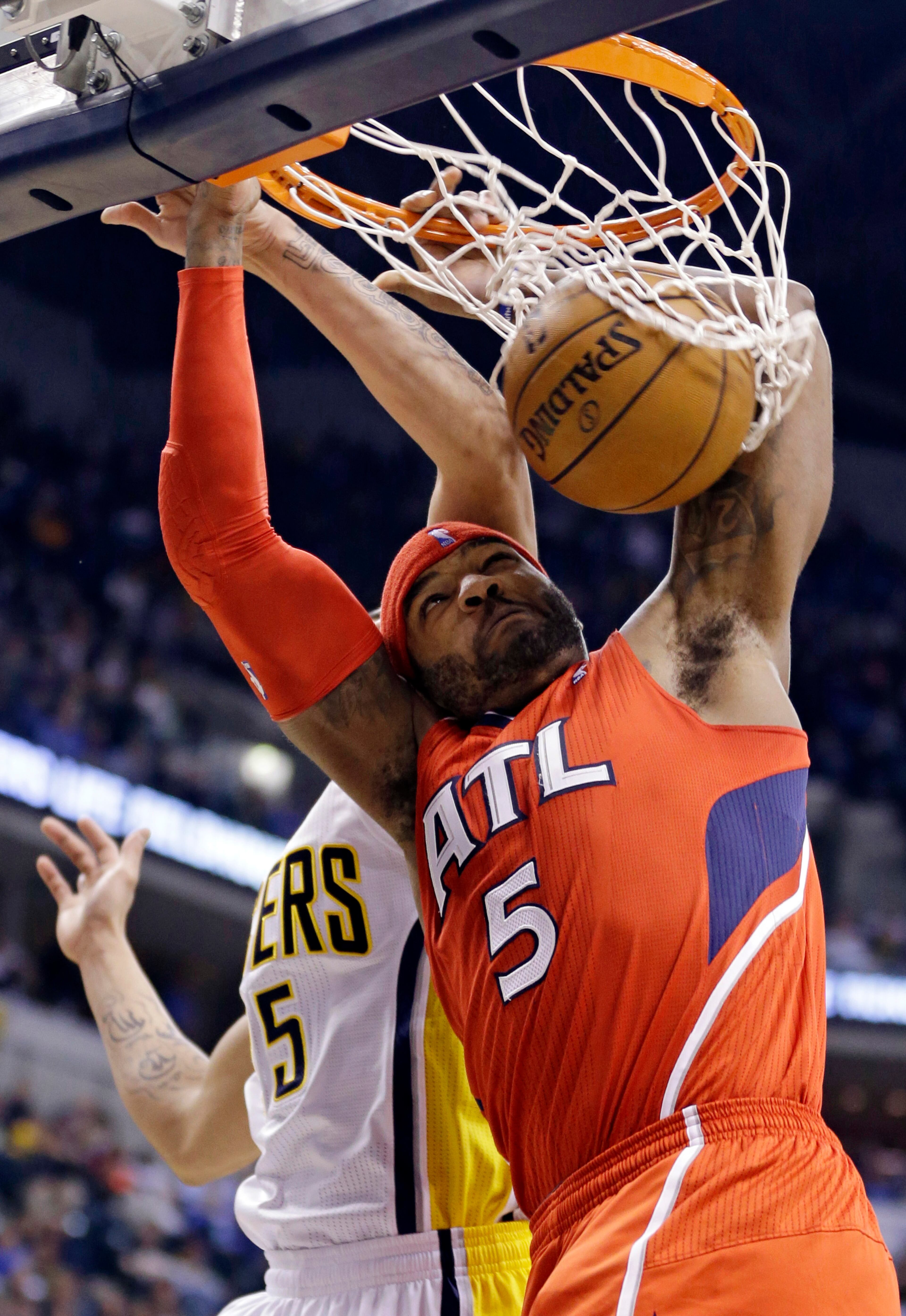 Atlanta Hawks forward Josh Smith (5) dunks under Indiana Pacers forward Gerald Green in the first half of Game 2 of their first-round NBA basketball playoff series in Indianapolis, Wednesday, April 24, 2013.