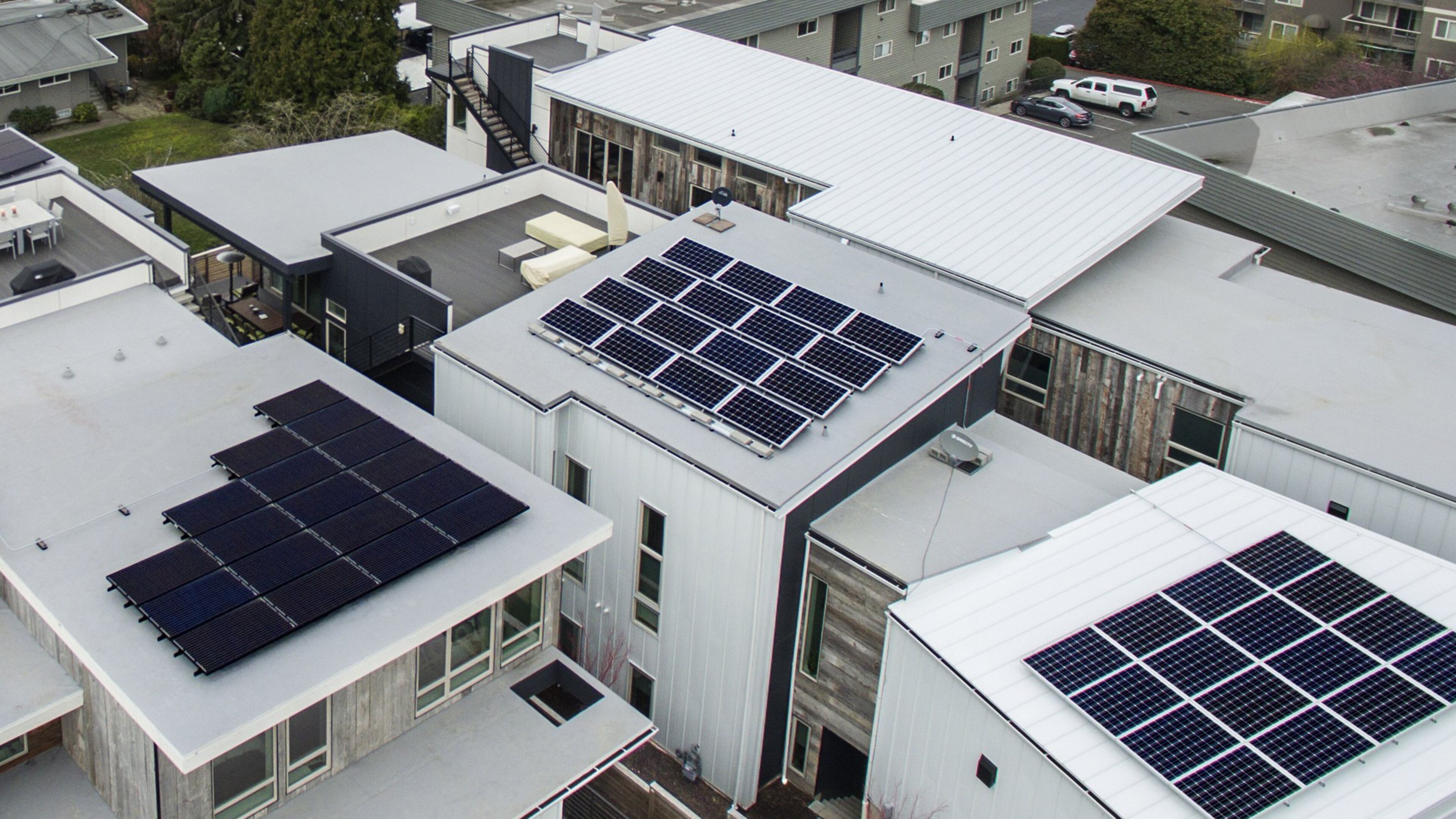 The Lakeview Solar Community in Kirkland, by Dwell Development and Medici Architects, is made up of two attached duplex units, left, and two single-family homes. “It’s a solar-ready community, and our shared driveway really feels like a community,” says homeowner Chris Voss. “There are themes between the four homes, but they’re not cookie-cutter; you can certainly tell they’re of the same mind.” (Steve Ringman/The Seattle Times/TNS)