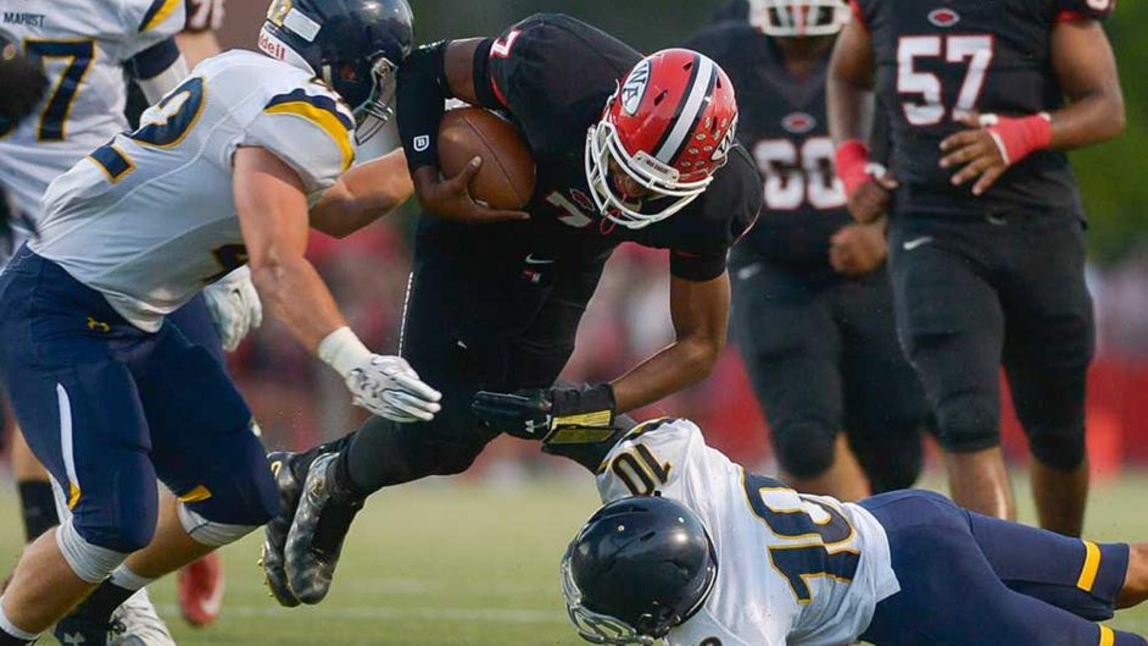 Woodward Academy quarterback Daniel Glover runs for yardage in a 2015 game between Woodward and Marist. The two schools that first met in football in the 1920s will renew their rivalry on Sept. 4.
