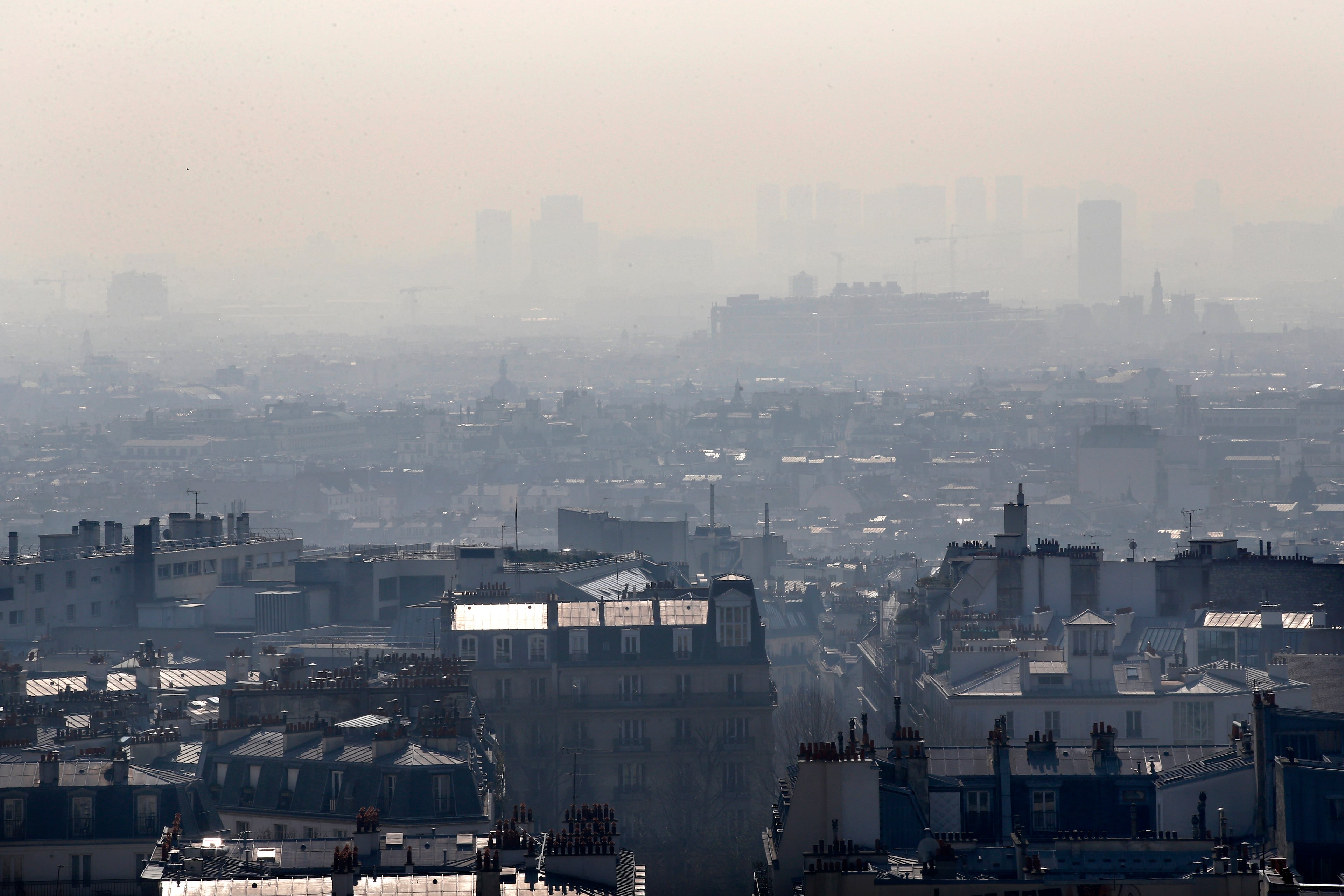 The center of Paris is seen through the smog, Thursday March 13, 2014, as pollution over the French capital is at high levels. In an official effort intended to curb air pollution, Paris Town Hall announced that residential parking will be free Thursday to encourage drivers to leave their cars at home and take public transportation.