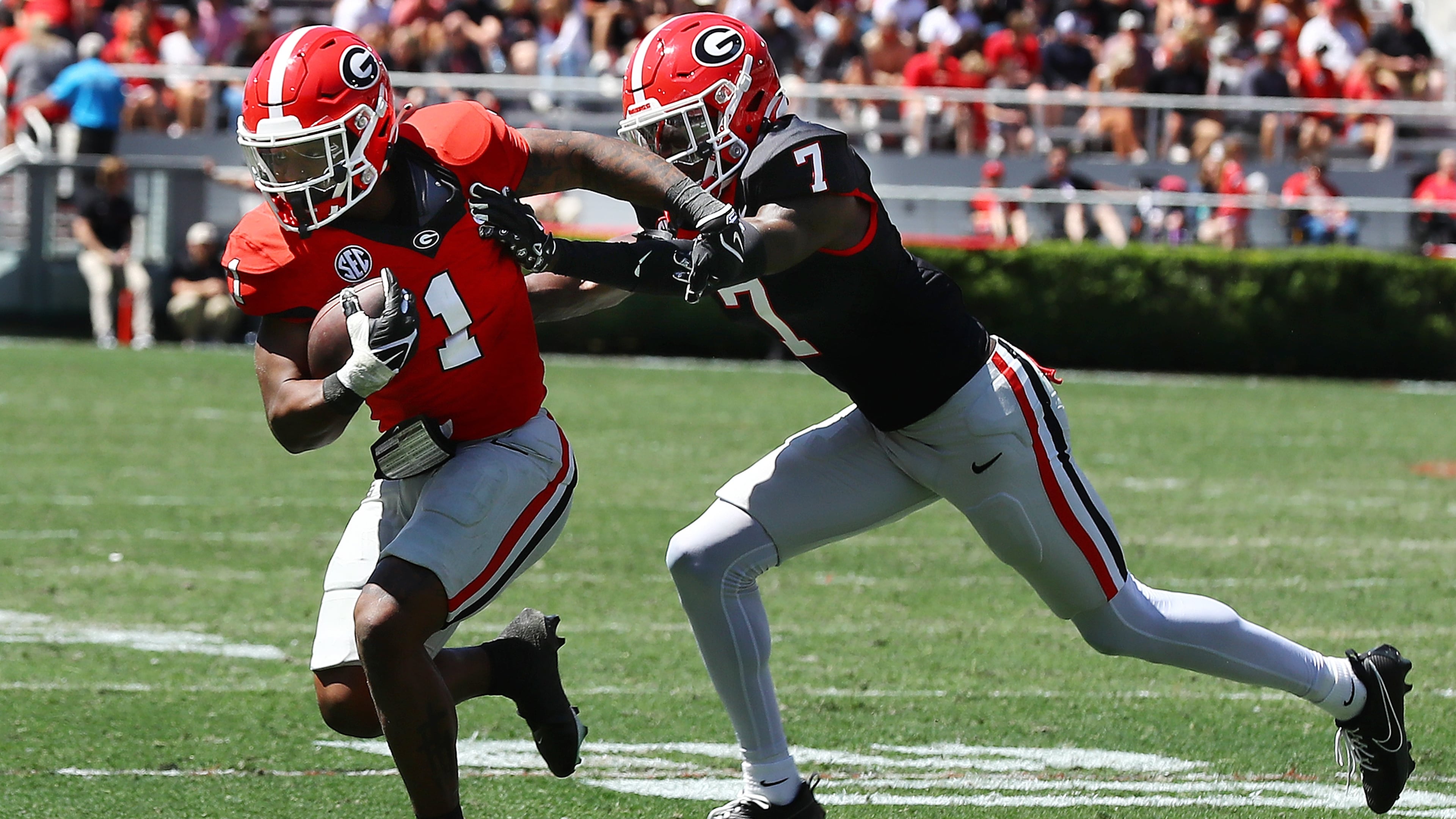 041324 Athens: Georgia running back Trevor Etienne catches a pass and picks up yardage past defensive back Daniel Harris during the G-Day game on Saturday, April 13, 2024. Curtis Compton for the Atlanta Journal Constitution