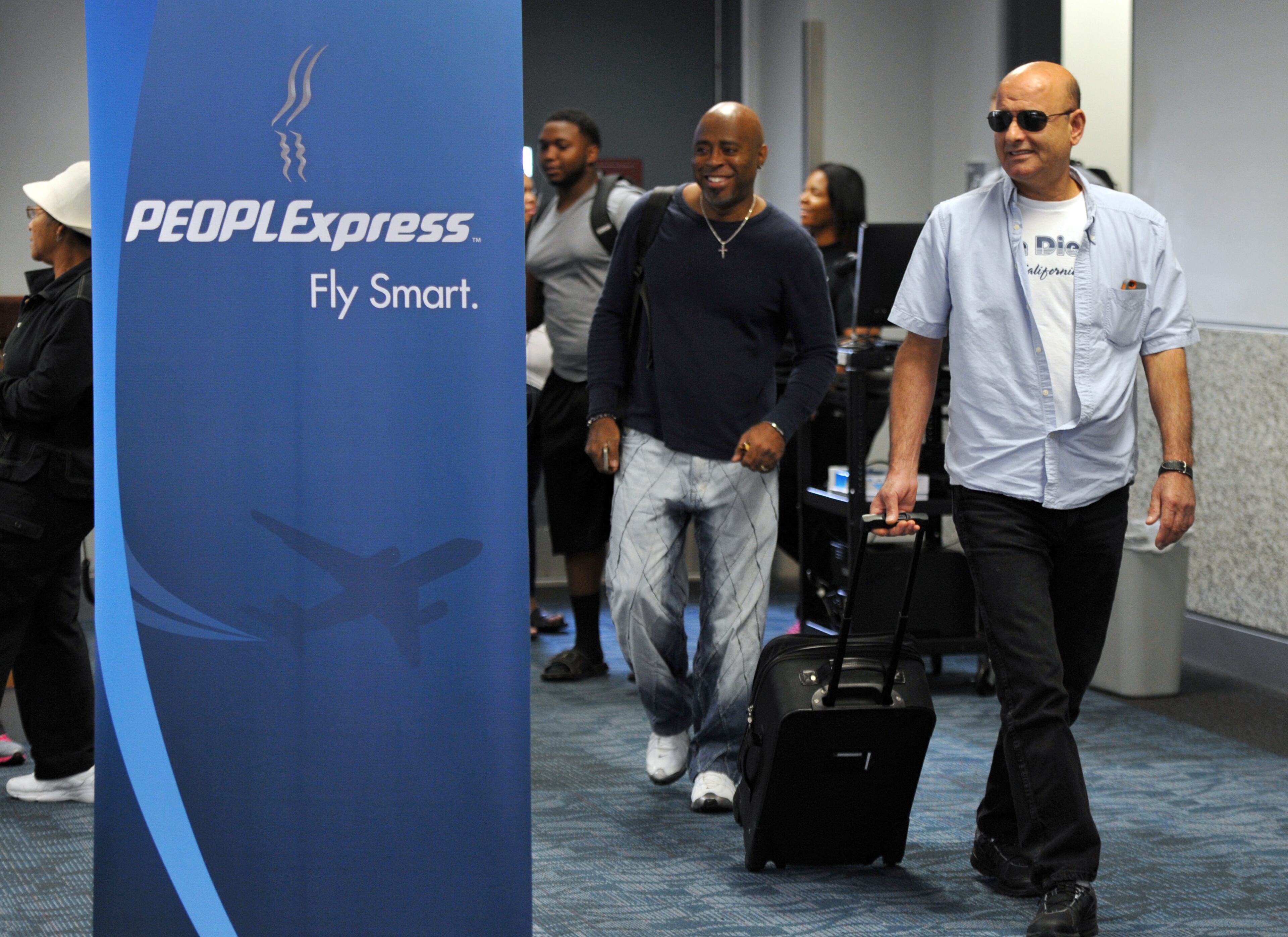August 1, 2014 Atlanta - Passengers arrive at Hartsfield-Jackson Atlanta International Airport from Newport News-Williamsburg International Airport on Friday, August 1, 2014. After nearly 30 years PEOPLExpress returns to Atlanta. Hartsfield-Jackson welcomed back PEOPLExpress on August 1 with a ribbon cutting ceremony and a water cannon salute for its first inbound and outbound flight. PEOPLExpress will run a low-fare service from Newport News-Williamsburg International Airport (Virginia) to Hartsfield-Jackson. HYOSUB SHIN / HSHIN@AJC.COM