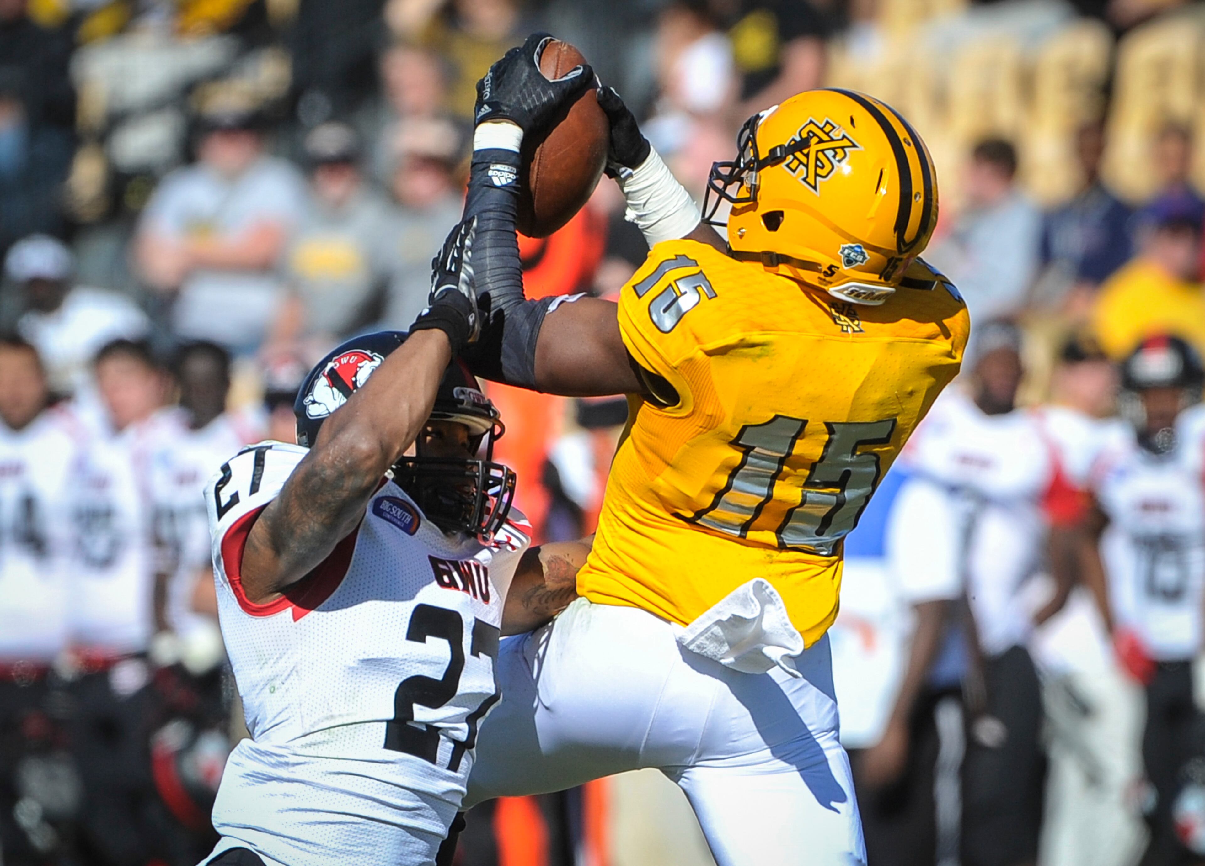 Kennesaw State wide receiver Justin Sumpter hauls in a pass defended by Gardner-Webb cornerback Jonathan Sherrill (27) on Saturday, Oct. 17, 2015, in Kennesaw, Ga. Kennesaw State defeated Gardner-Webb 12-7. (Photo/John Amis)