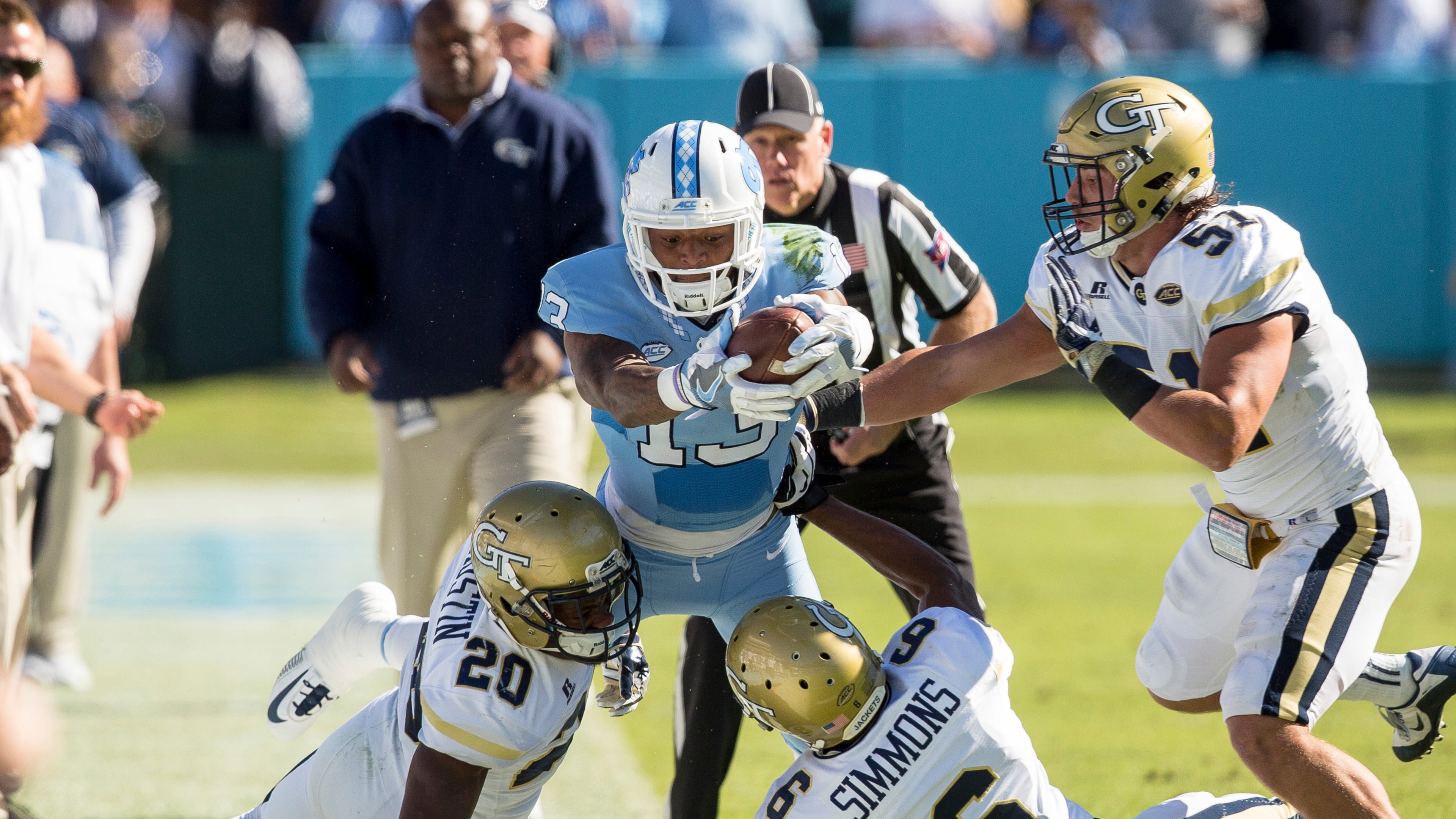 North Carolina’s Bug Howard (13) attempts to stretch for a first down as Georgia Tech’s Lawrence Austin (20), Lamont Simmons (6), and Brant Mitchell (51) defend during the first half of an NCAA college football game Chapel Hill, N.C., Saturday, Nov. 5, 2016. (AP Photo/Ben McKeown)