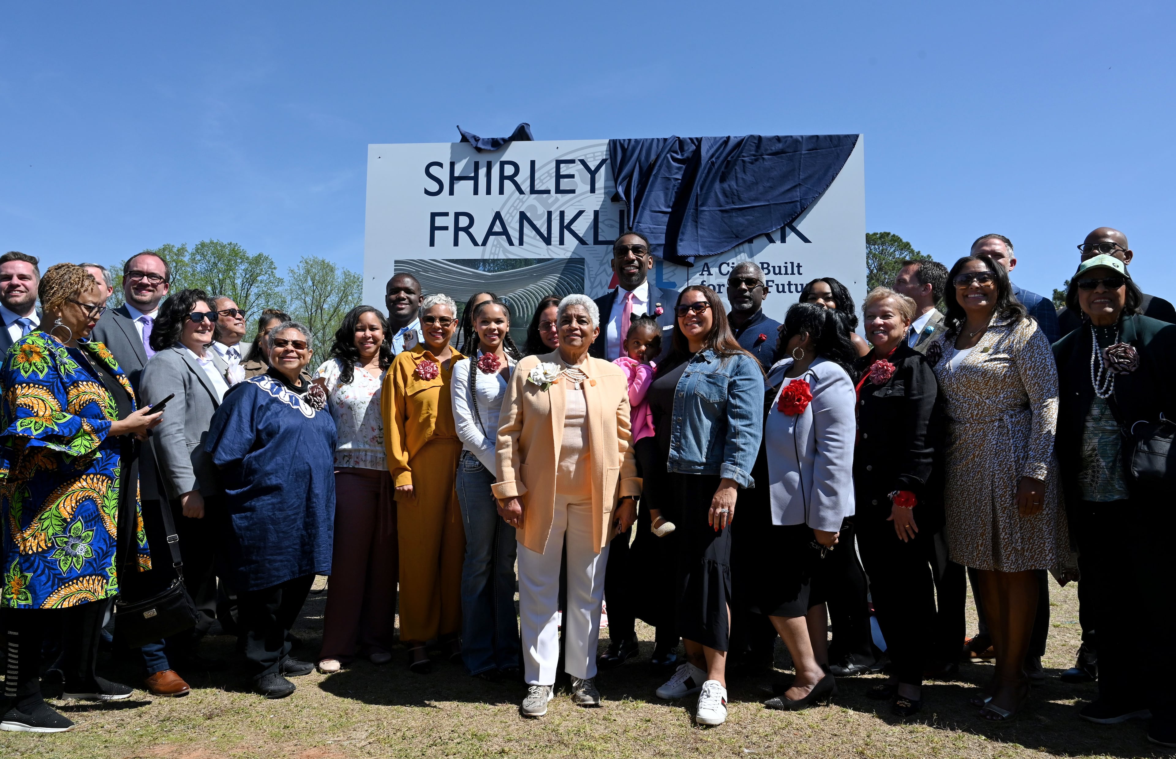 Former Atlanta mayor Shirley Franklin (center) is surrounded by guests as new sign of Shirley Clarke Franklin Park is unveiled March 27 in Atlanta. (Hyosub Shin/AJC)