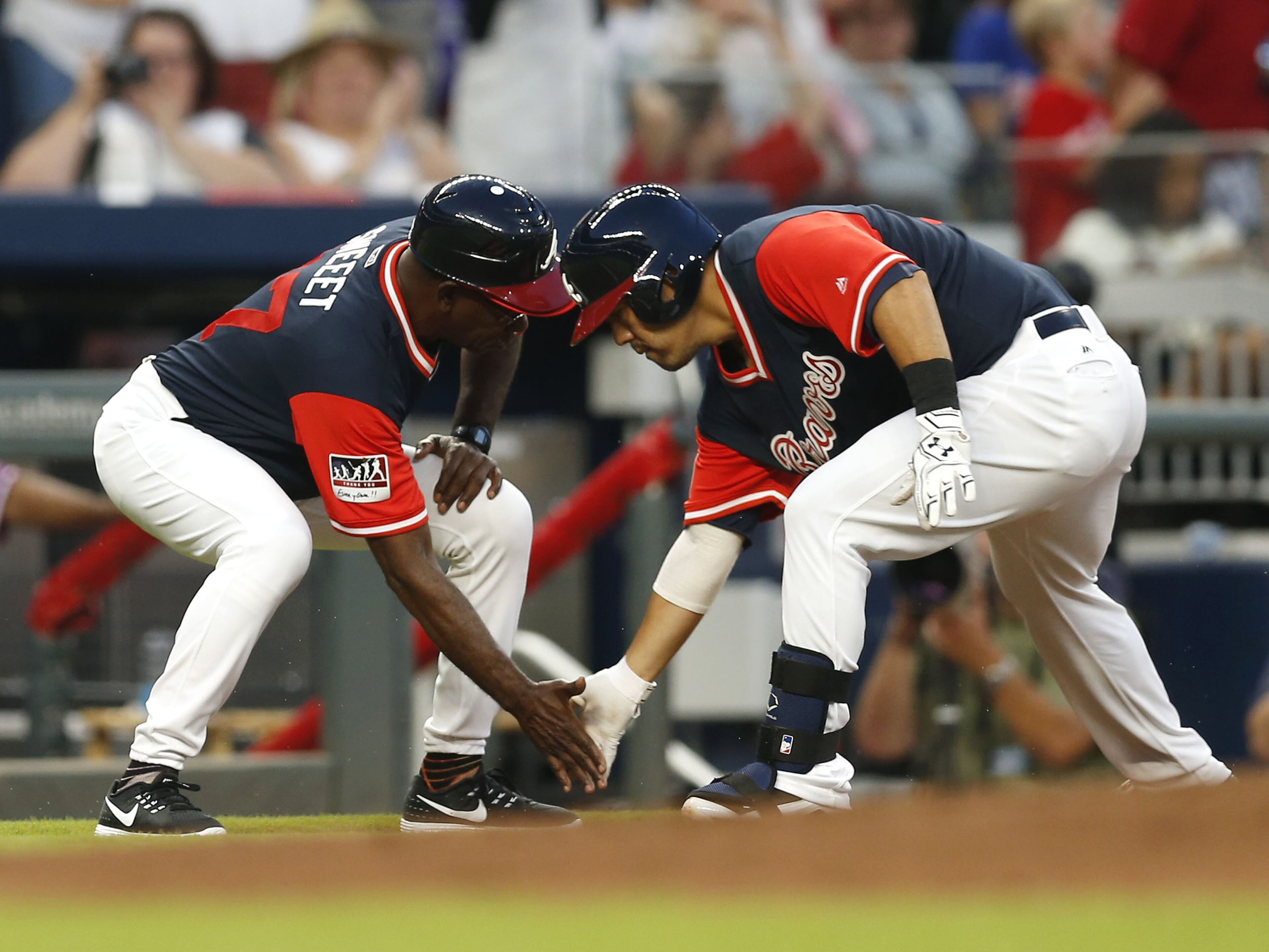 ATLANTA, GA - AUGUST 25: Catcher Kurt Suzuki #24 of the Atlanta Braves is congratulated by third base coach Ron Washington #37 after Suzuki's home run in the second inning during the game against the Colorado Rockies at SunTrust Park on August 25, 2017 in Atlanta, Georgia. (Photo by Mike Zarrilli/Getty Images)