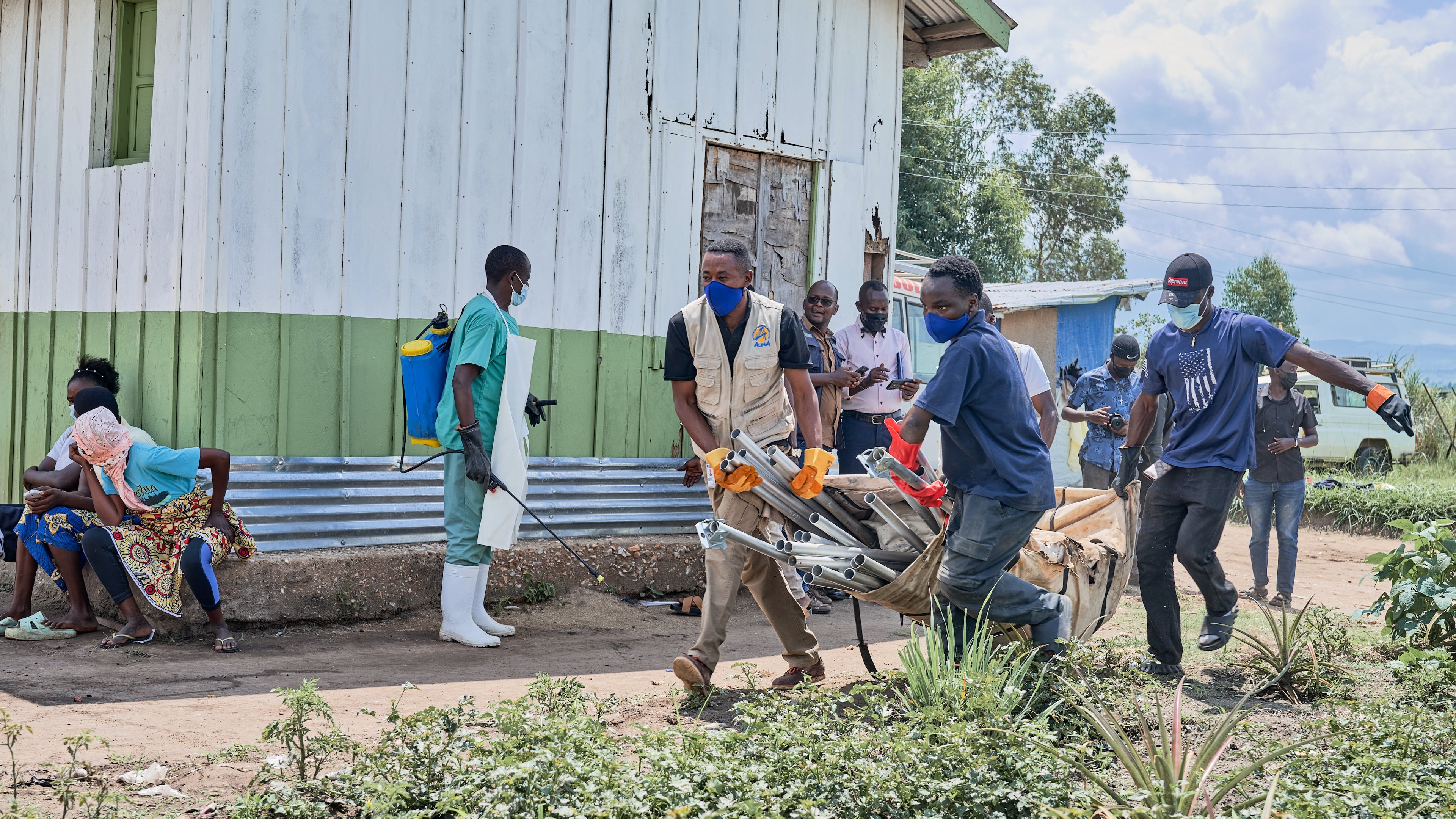 Aid workers carry supplies to set up an Ebola treatment center in Bunia, Congo, Tuesday, May 19, 2026. (AP Photo/Dirole Lotsima Dieudonne)