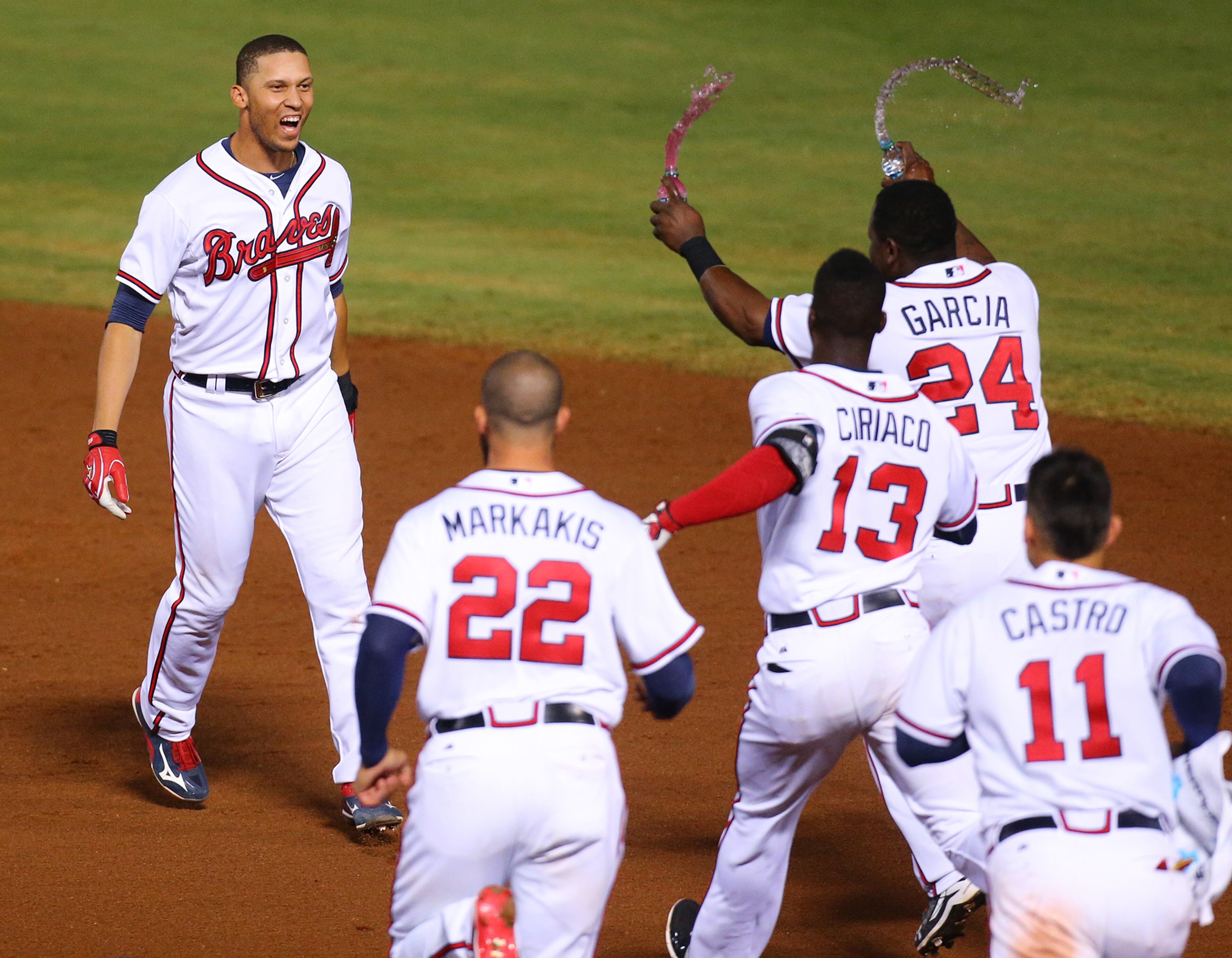 Teammates charge Braves Andrelton Simmons after he hit a walk off game winning RBI single to beat the Blue Jays 3-2 in the 9th inning of a baseball game on Tuesday, Sept. 15, 2015, in Atlanta. Curtis Compton / ccompton@ajc.com