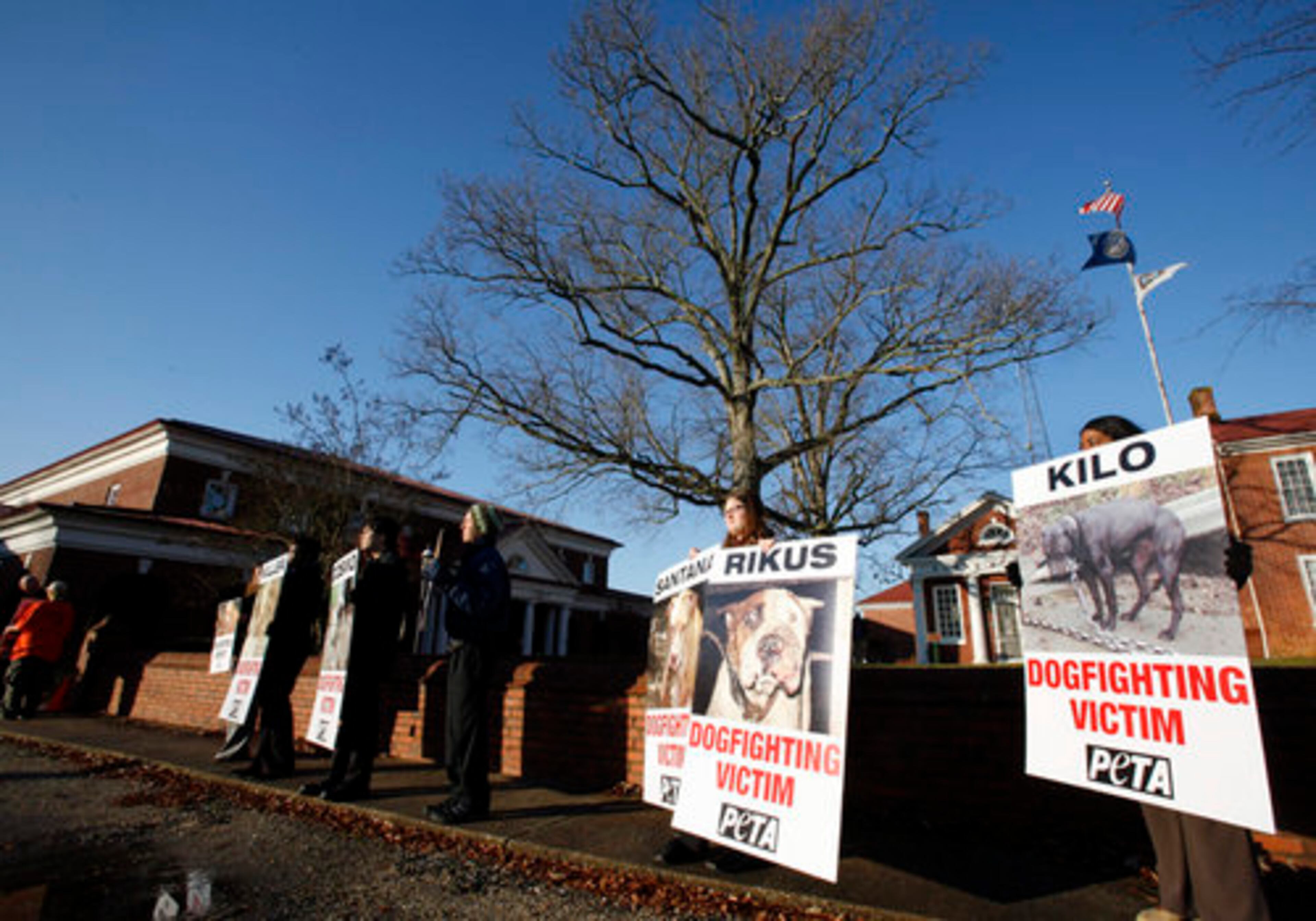PETA protesters hold signs Tuesday.