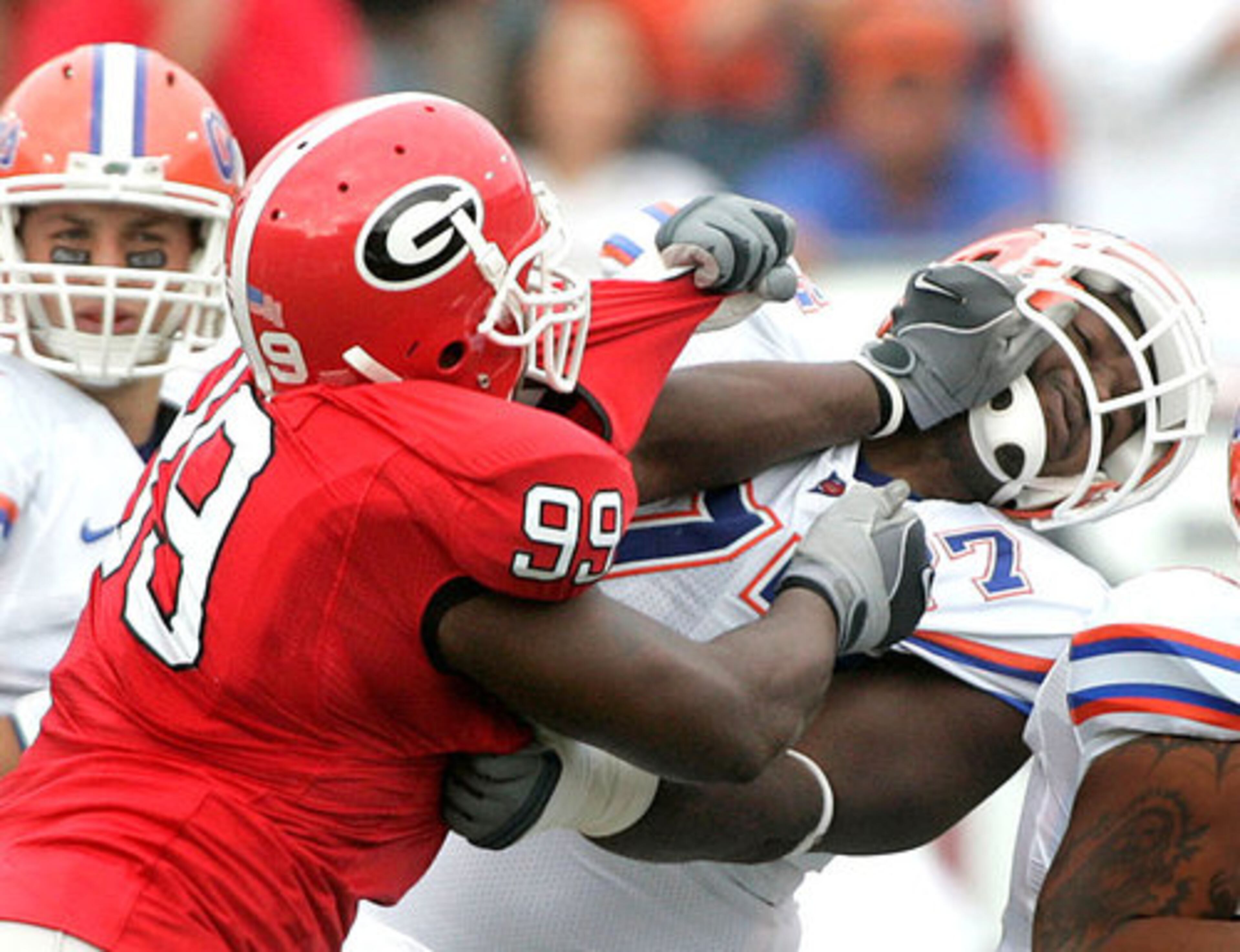 Florida lineman Jason Watkins, right, attempts to block Georgia defensive tackle Jarius Wynn (99). Wynn responds with a left to the facemask.