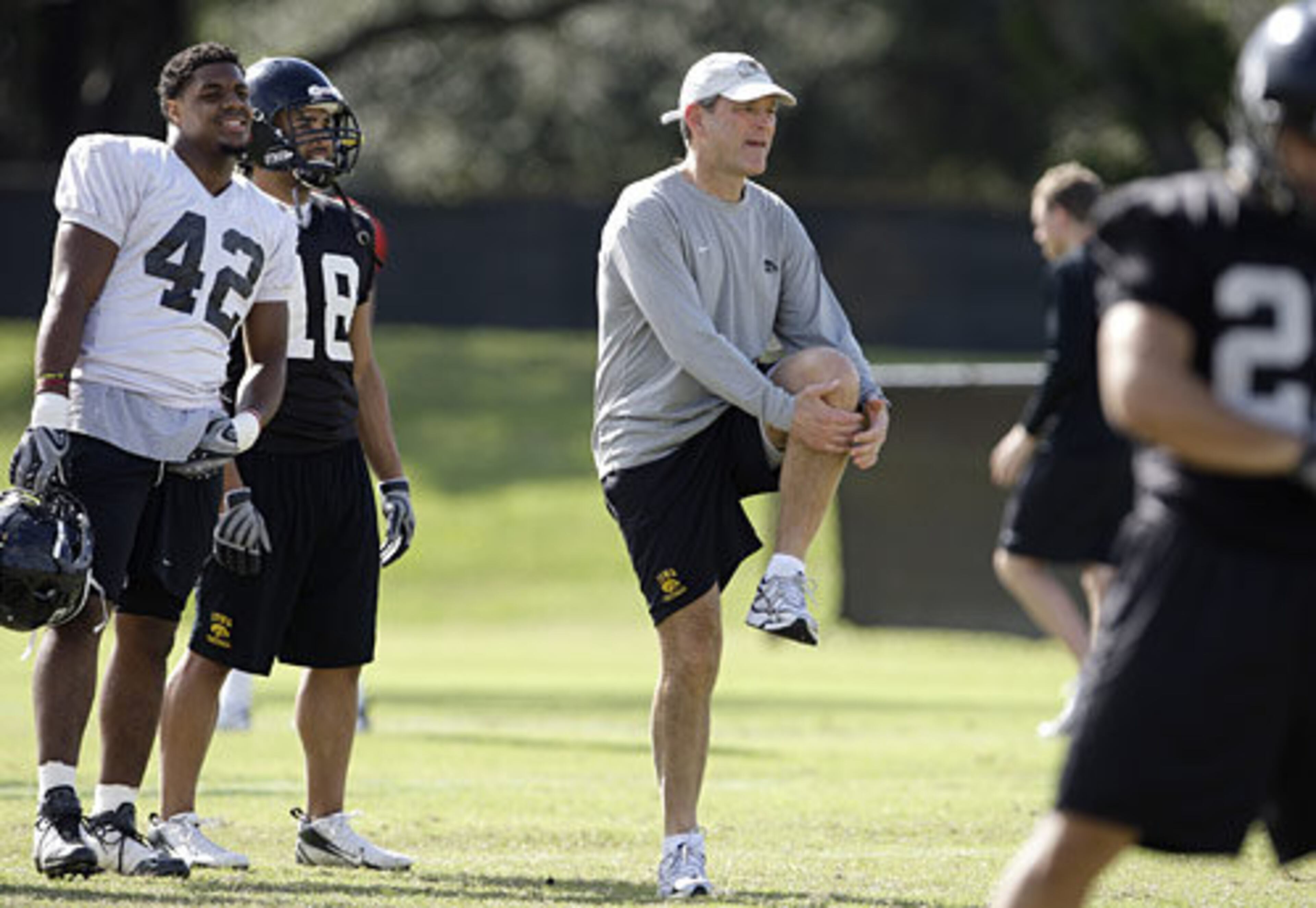 Hawkeyes coach Kirk Ferentz (center) leads his squad through stretching exercises as they prepare to meet Georgia Tech Jan. 5, 2010.