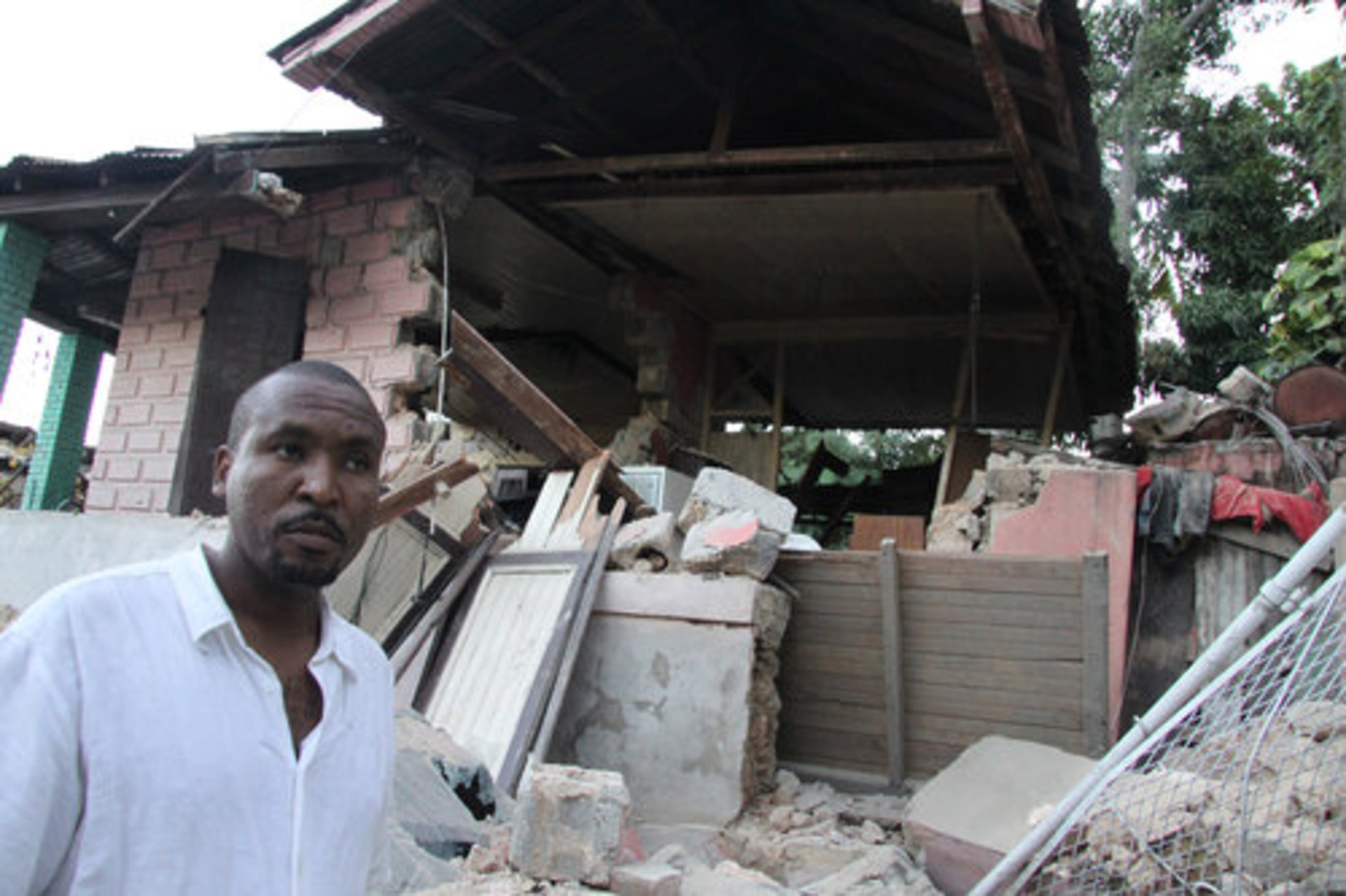 A man looks over the rubble of his home in Port-au-Prince, Haiti, on Wednesday, Jan. 13, 2010. Huge swaths of Port-au-Prince lay in ruins, and thousands of people were feared dead in the rubble of government buildings, foreign aid headquarters and shantytowns that collapsed a day earlier in a powerful earthquake.