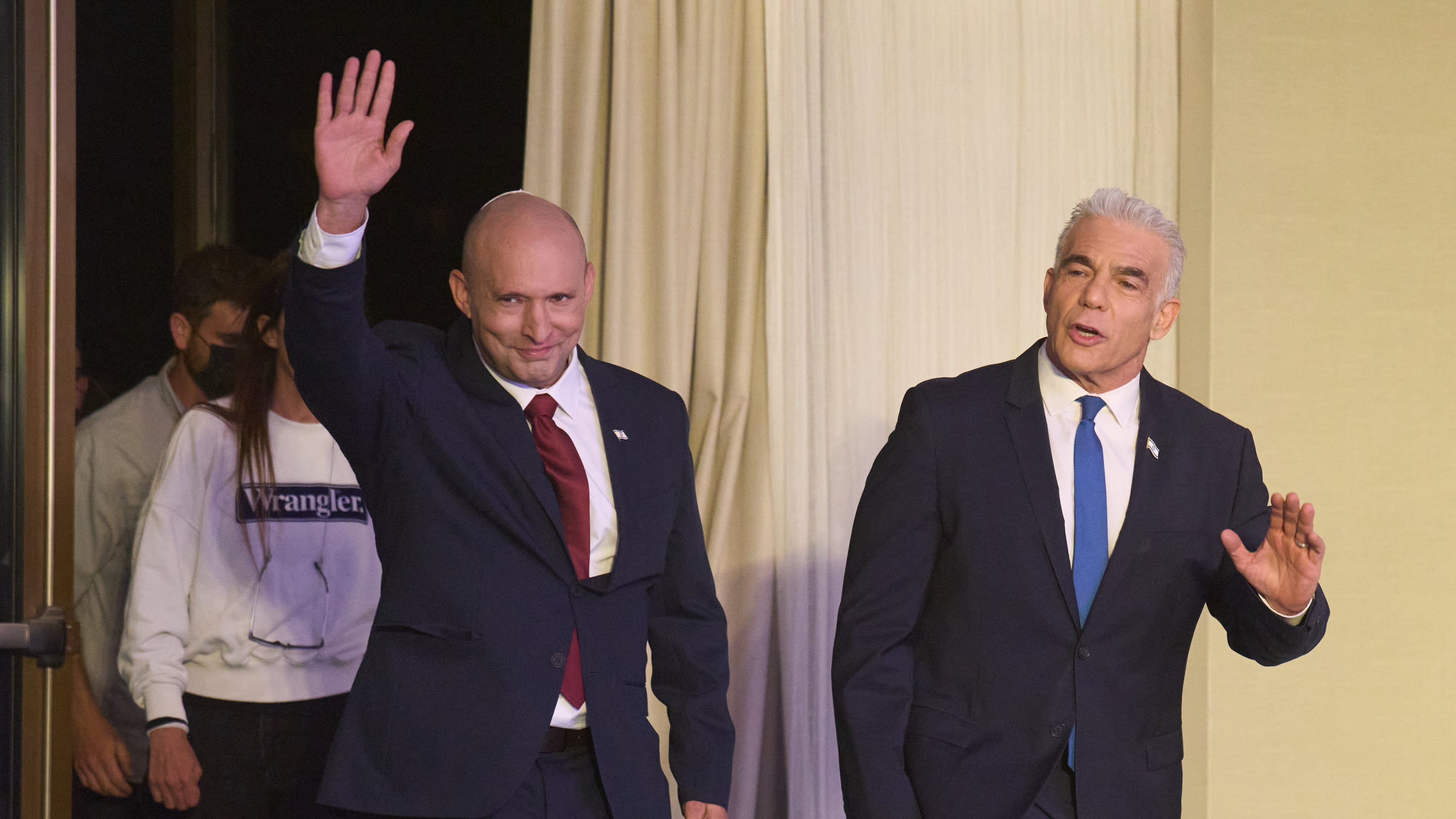 Former Israeli prime ministers Naftali Bennett, left, and Yair Lapid arrive to a joint press conference announcing that their parties will run together in the upcoming elections, in Herzliya, Israel, Sunday, April 26, 2026. (AP Photo/Ariel Schalit)