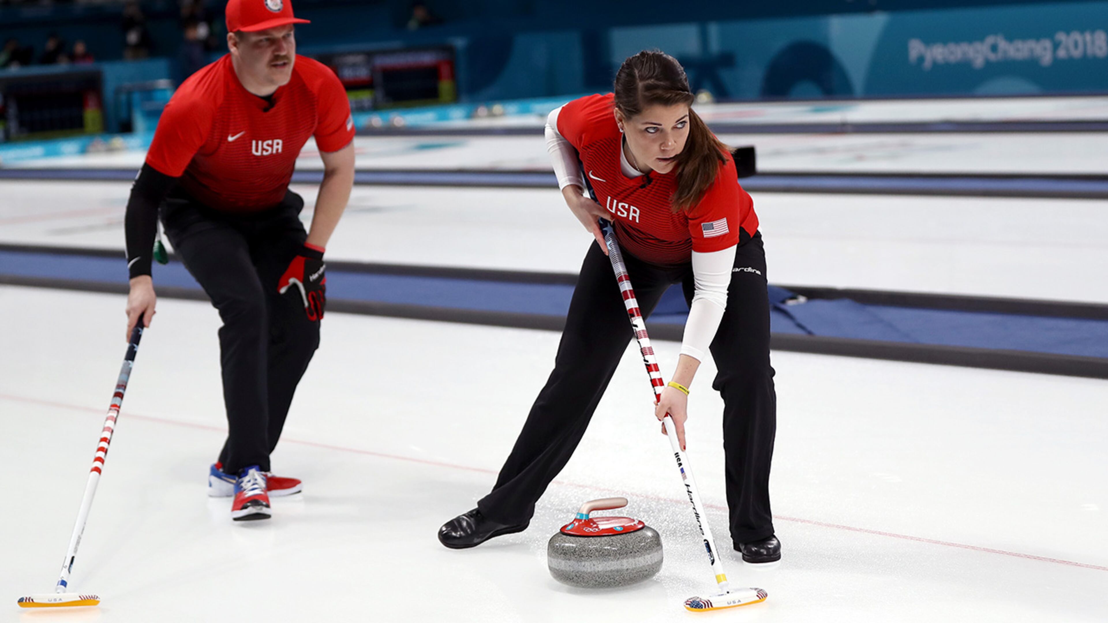 PYEONGCHANG-GUN, SOUTH KOREA - FEBRUARY 08: Becca Hamilton and Matt Hamilton of the United States deliver a stone in the Curling Mixed Doubles Round Robin Session 1 during the PyeongChang 2018 Winter Olympic Games at Gangneung Curling Centre on February 8, 2018 in Pyeongchang-gun, South Korea. (Photo by Ronald Martinez/Getty Images)