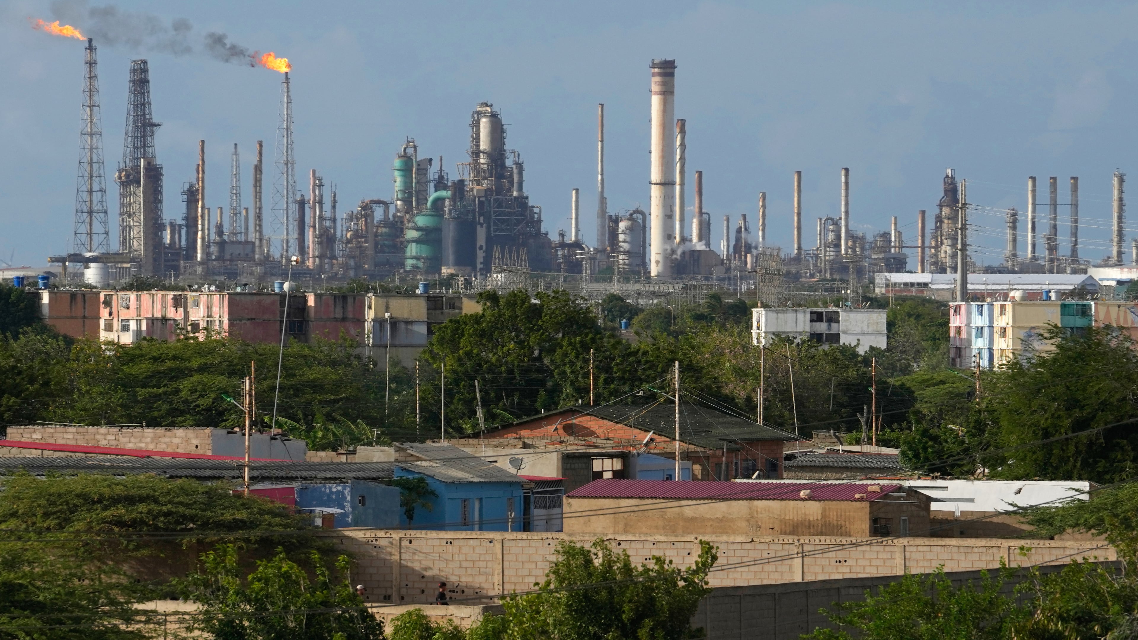 FILE - Flames rise from flare stacks at the Amuay refinery in Los Taques, Venezuela, Jan. 14, 2026. (AP Photo/Matias Delacroix, File)