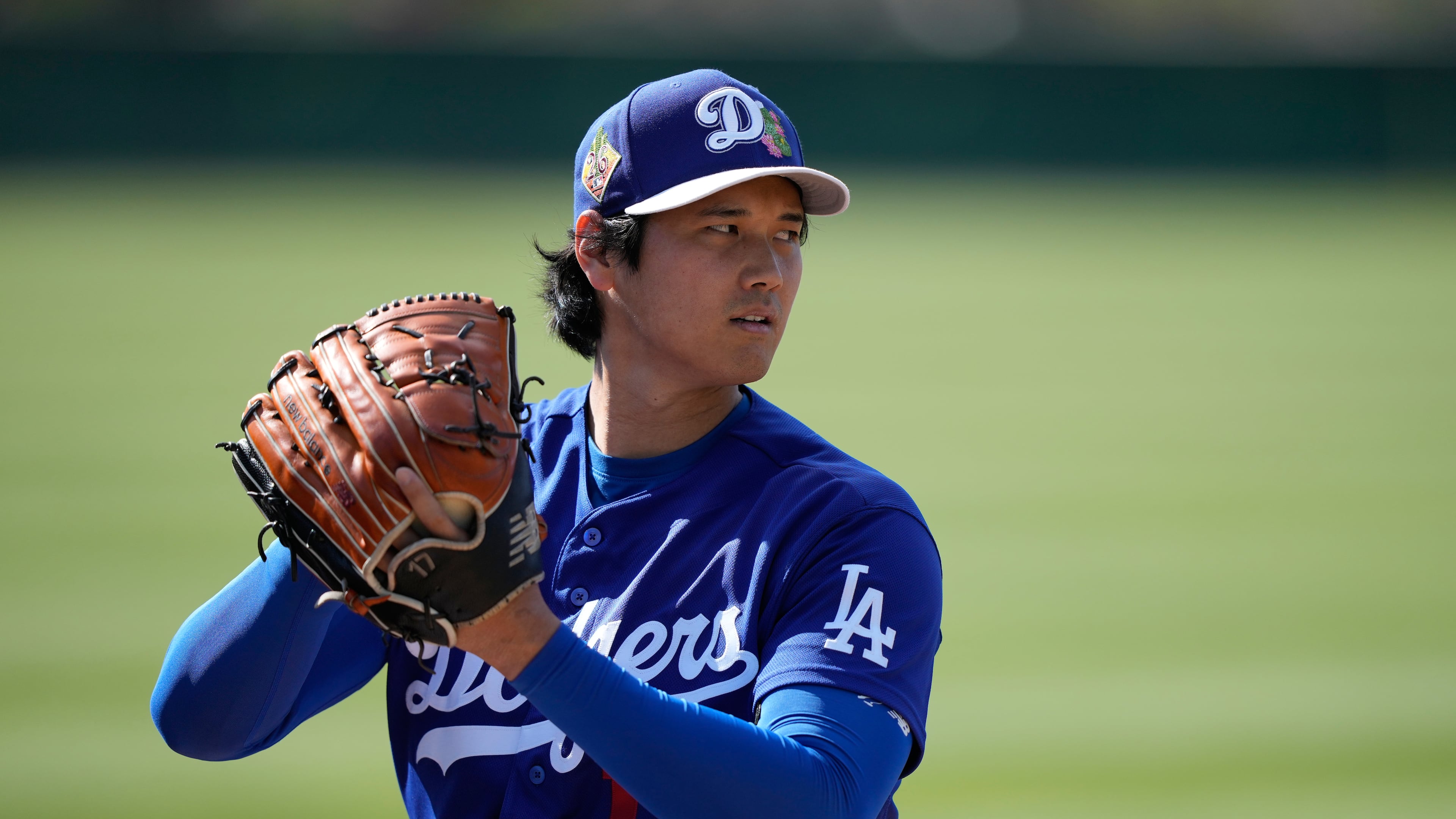 Los Angeles Dodgers two-way player Shohei Ohtani (17) warms up during spring training baseball on Sunday, Feb. 22, 2026, in Phoenix. (AP Photo/Brynn Anderson)