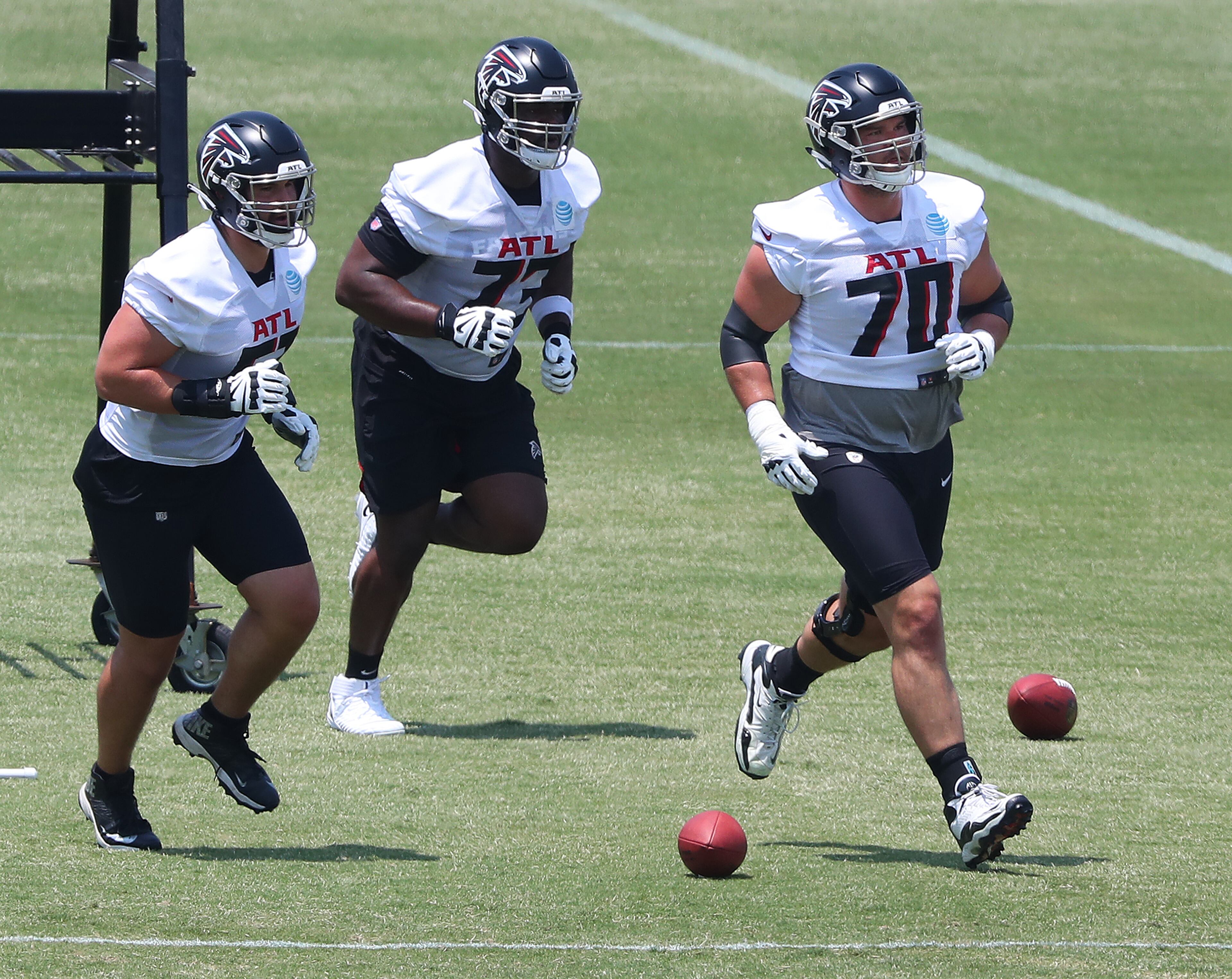 Falcons tackle Jake Matthews (right) leads Brandon Copeland (left) and Matt Gono through an offensive line drill during organize team activities (OTAs) Tuesday, May 25, 2021, at the team training facility in Flowery Branch. (Curtis Compton / Curtis.Compton@ajc.com)