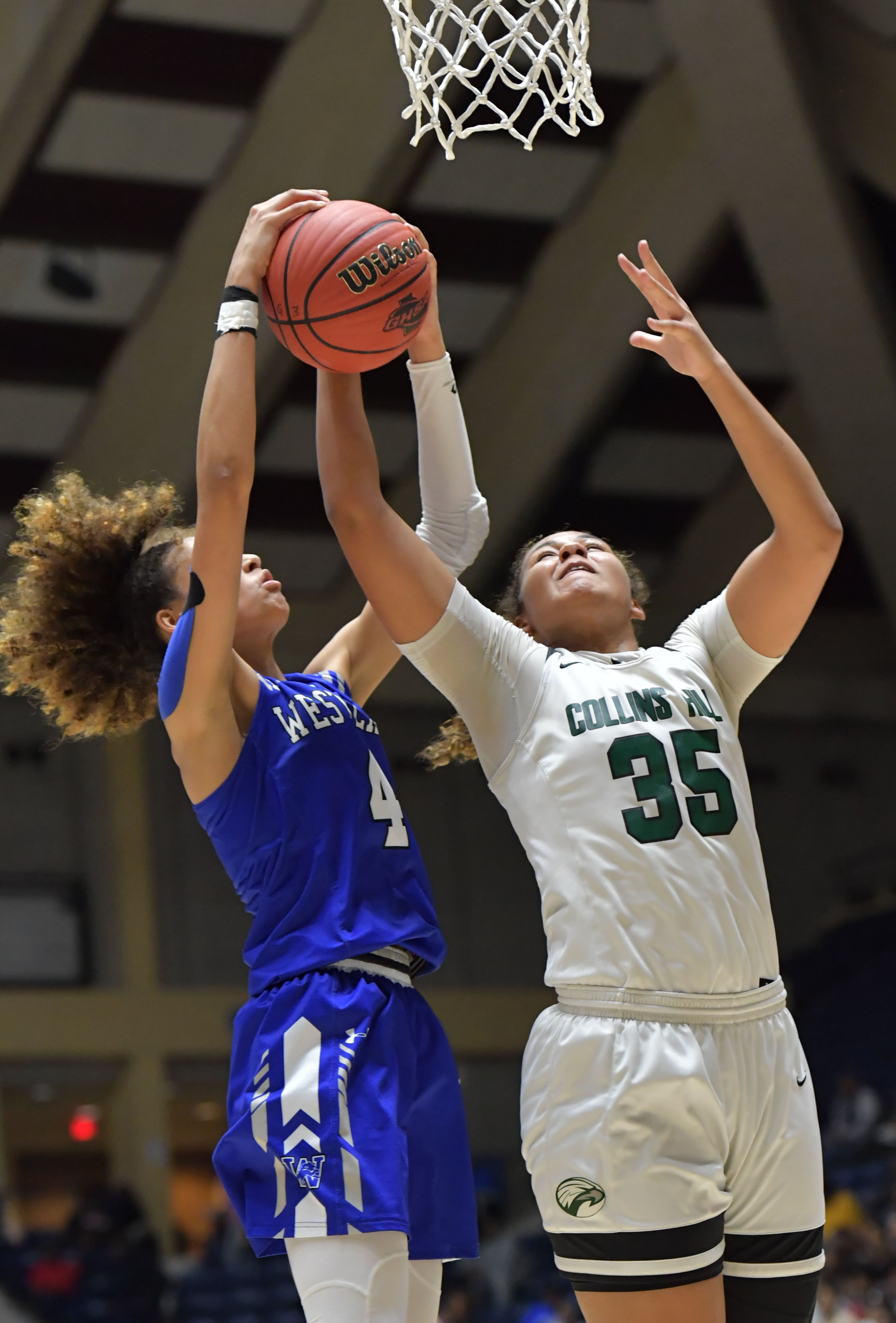 March 9, 2019 Macon - Westlake Brianna Turnage (4) and Collins Hill Javyn Nicholson (35) fight for a rebound in GHSA State Basketball Championship game at the Macon Centreplex in Macon on Saturday, March 9, 2019. HYOSUB SHIN / HSHIN@AJC.COM