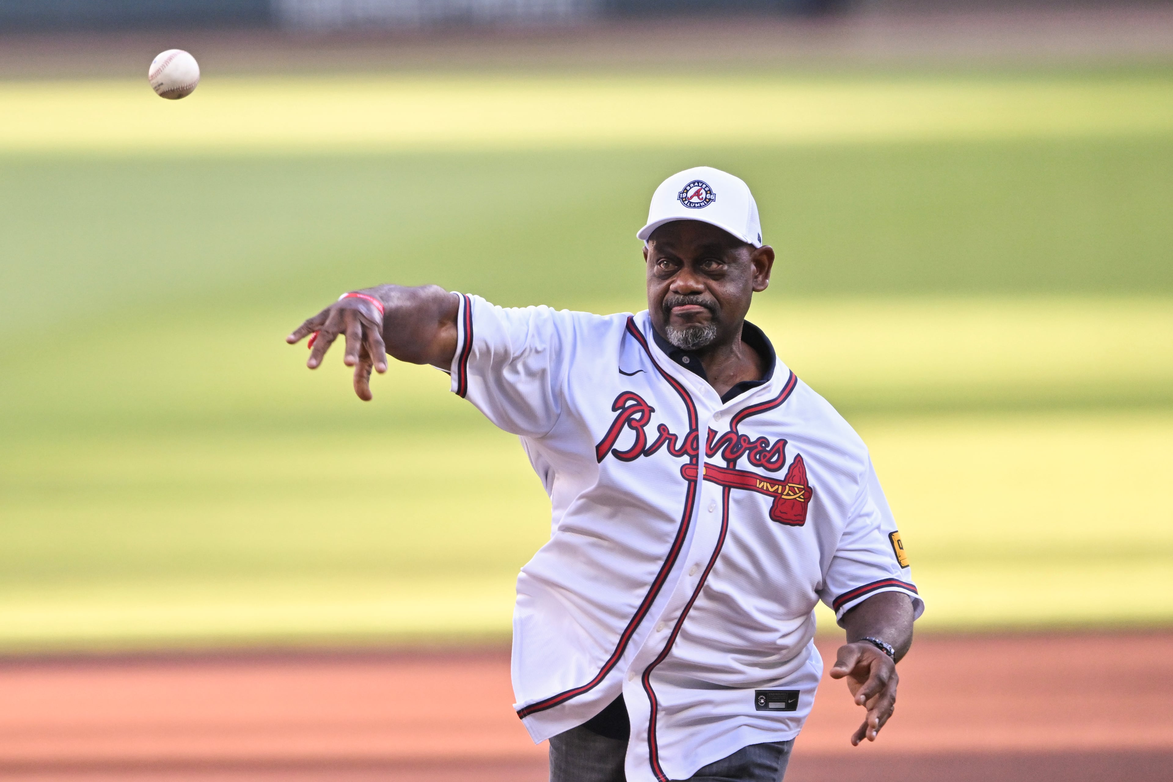 Former Atlanta Braves player Marquis Grissom throws out the ceremonial first pitch before Game 4 of the MLB National League Division Series between the Atlanta Braves and the Los Angeles Dodgers, Wednesday, Oct. 7, 2026, in Atlanta. (Hyosub Shin/AJC)
