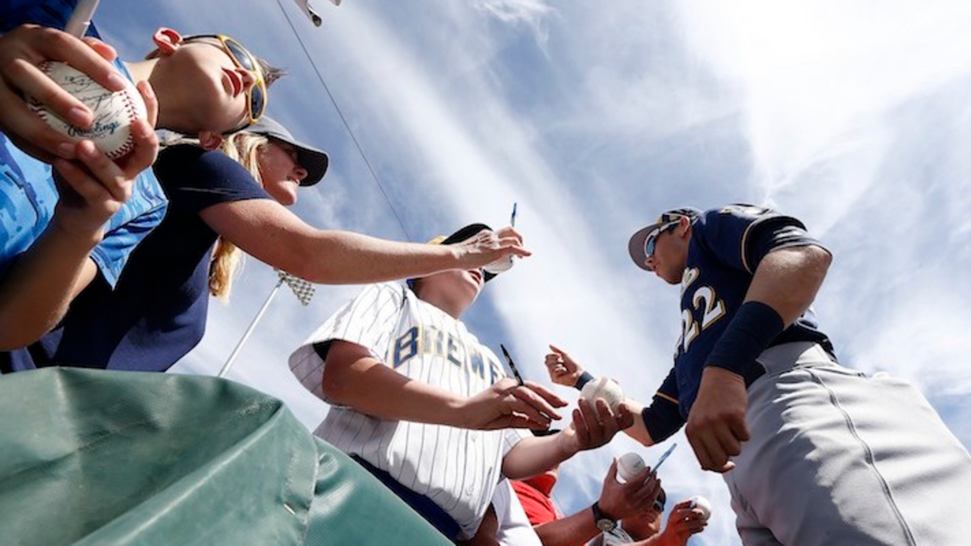Milwaukee Brewers' Christian Yelich signs autographs for fans prior to a spring training baseball game against the Chicago White Sox Tuesday, March 6, 2018, in Glendale, Ariz. The White Sox defeated the Brewers 6-4. (AP Photo/Ross D. Franklin)