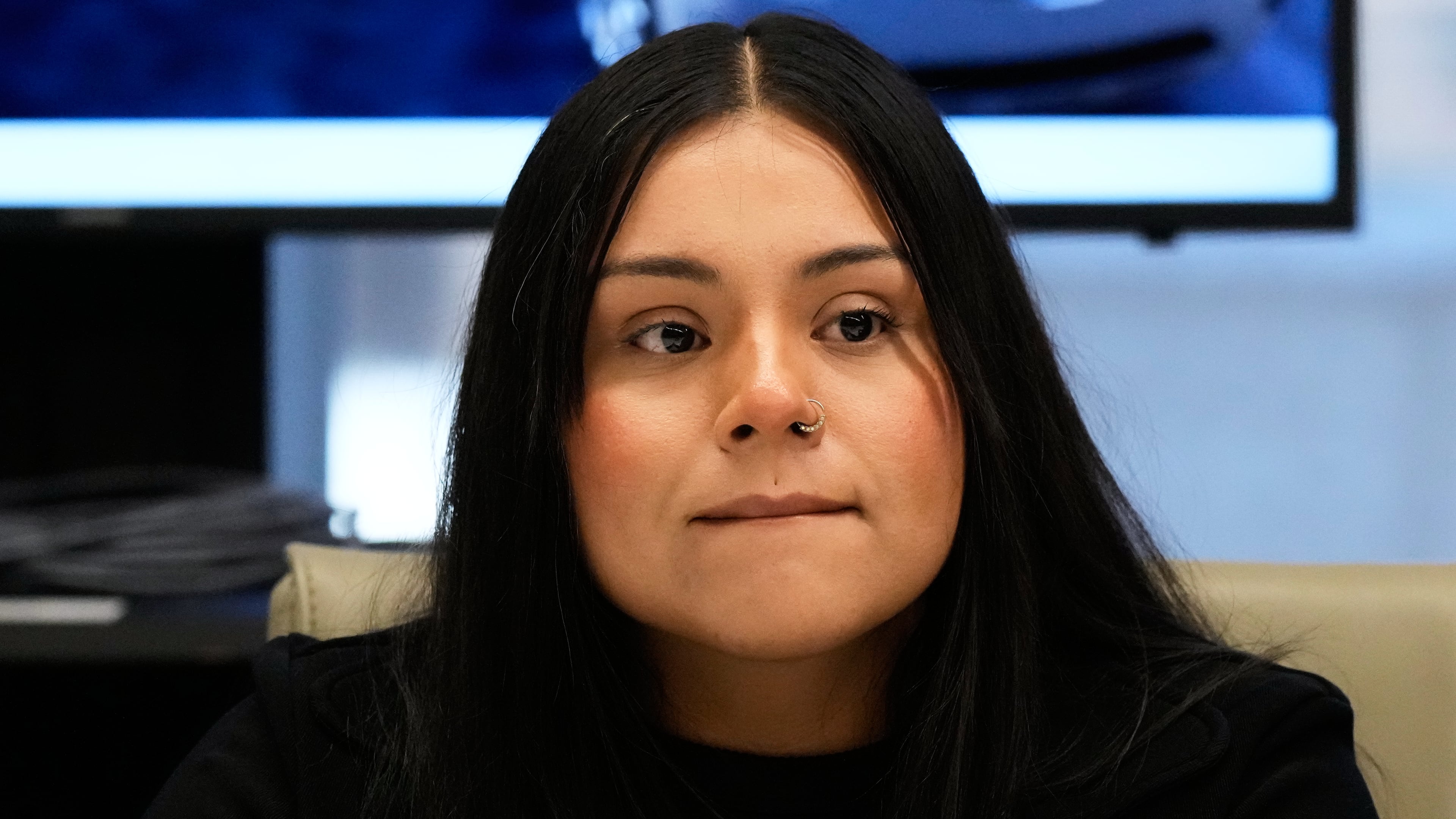 Marimar Martinez, a Chicago woman who was shot by a Border Patrol agent last year, listens to attorney Christopher Parente at a press conference Monday, Oct. 5, 2026, in Chicago. (AP Photo/Nam Y. Huh)