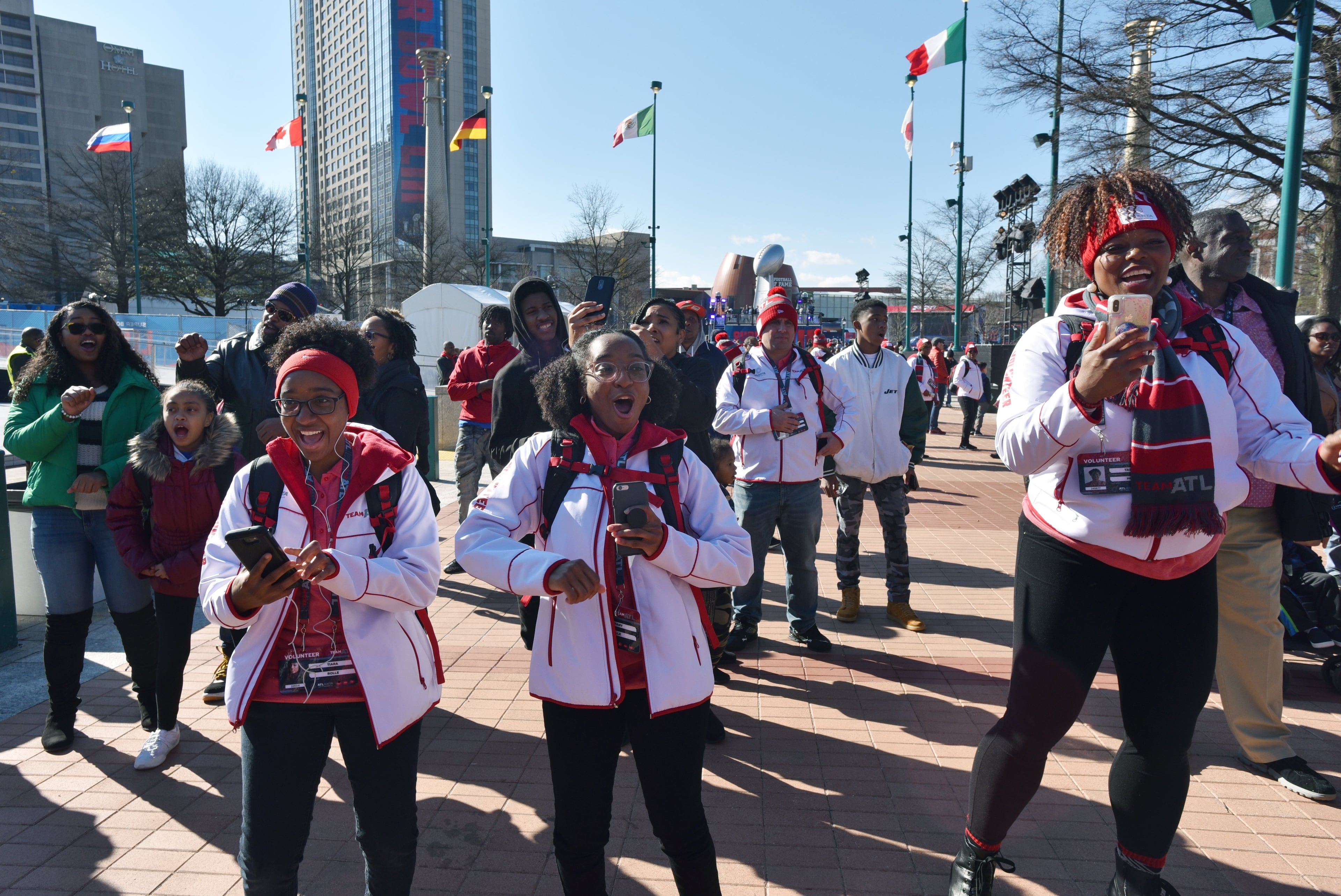 Volunteers dance at Super Bowl Live, a fan village featuring concerts and other attractions, in Centennial Olympic Park. on Saturday, Jan. 26, 2019. Admission is free to Super Bowl Live, which will be open daily through Feb. 2, except for Tuesday and Wednesday. (HYOSUB SHIN / HSHIN@AJC.COM)