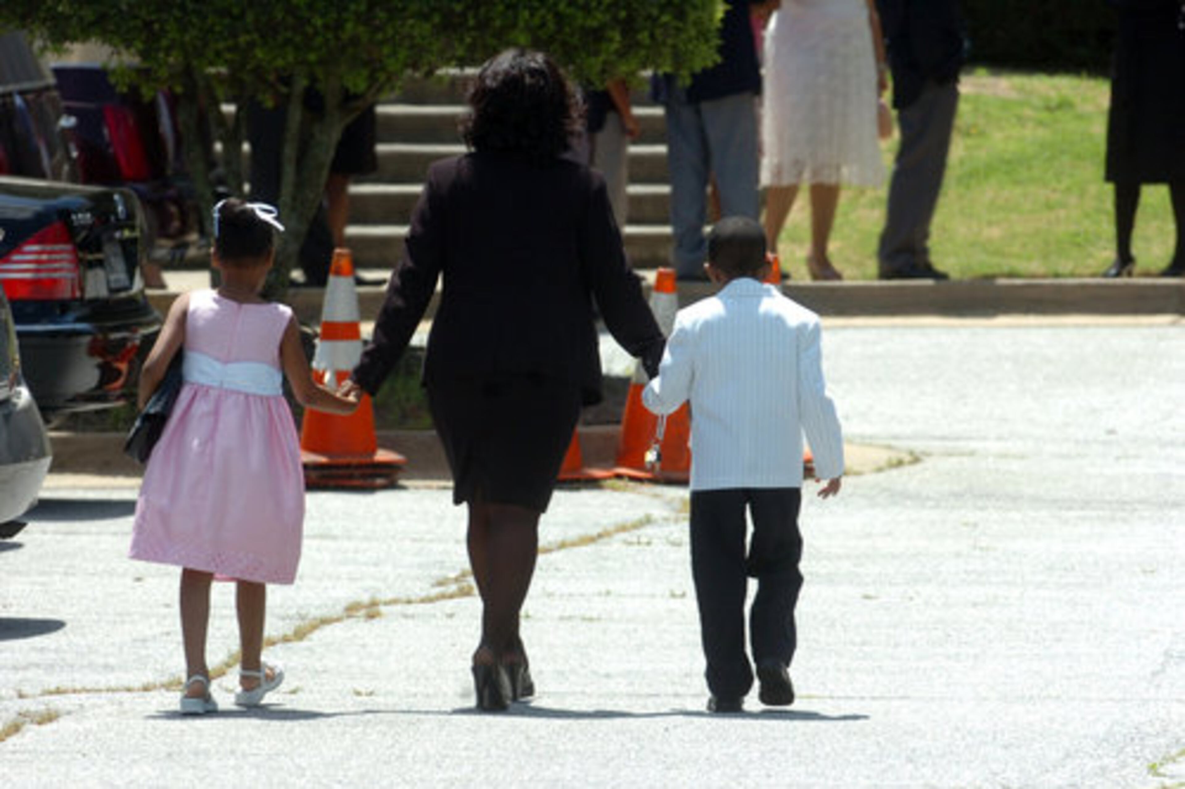 A woman with two young children at Monday's service.