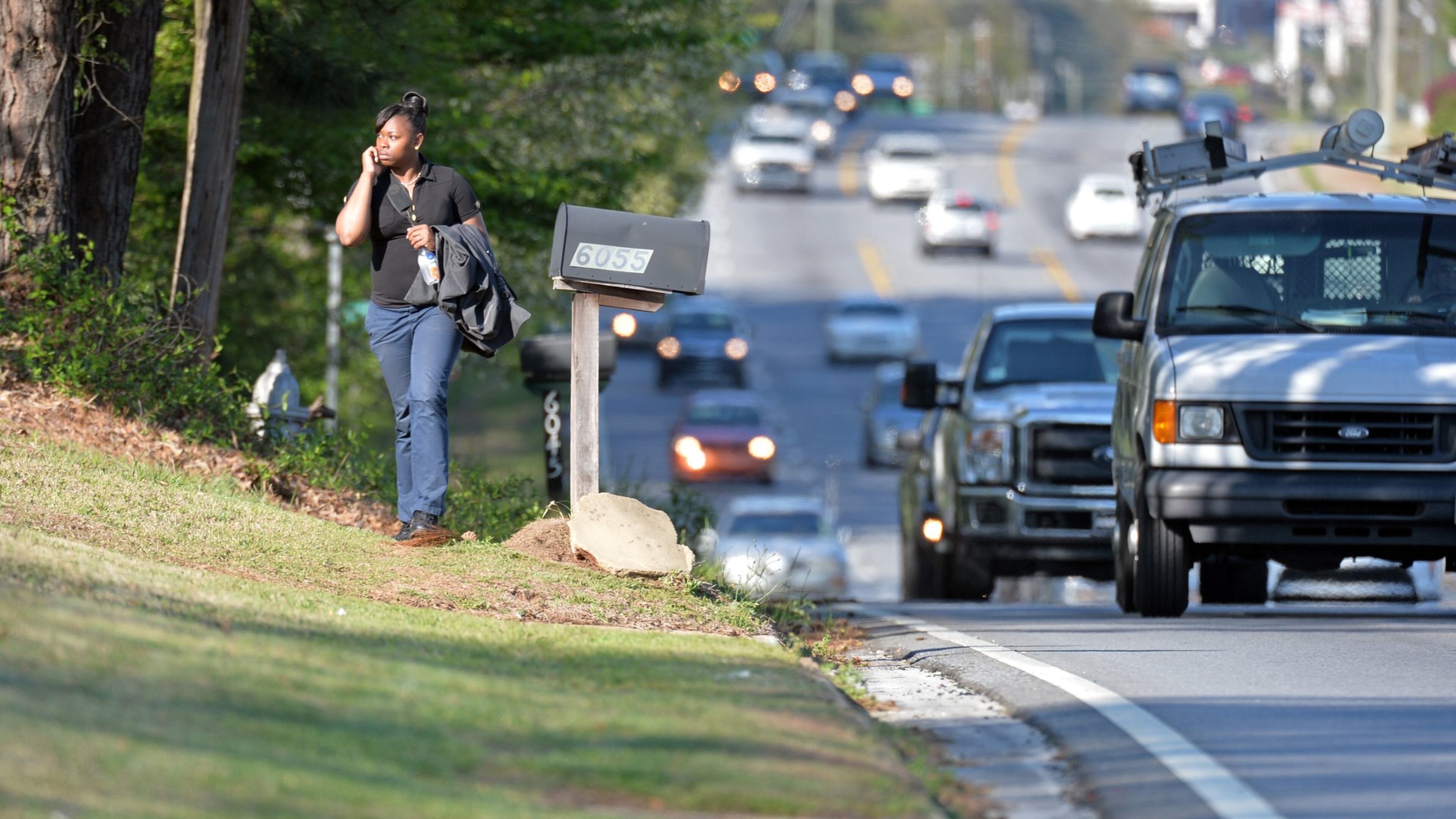Alberta Watson, of Stone Mountain, walks several blocks along Lawrenceville Highway in Gwinnett County to meet her husband getting a ride on Wednesday, April 9, 2014. Gwinnett commissioners will vote next week on how to spend an expected $225 million in SPLOST proceeds on transportation projects. A citizens committee has recommended a long list of projects, including some 28 miles of sidewalks.