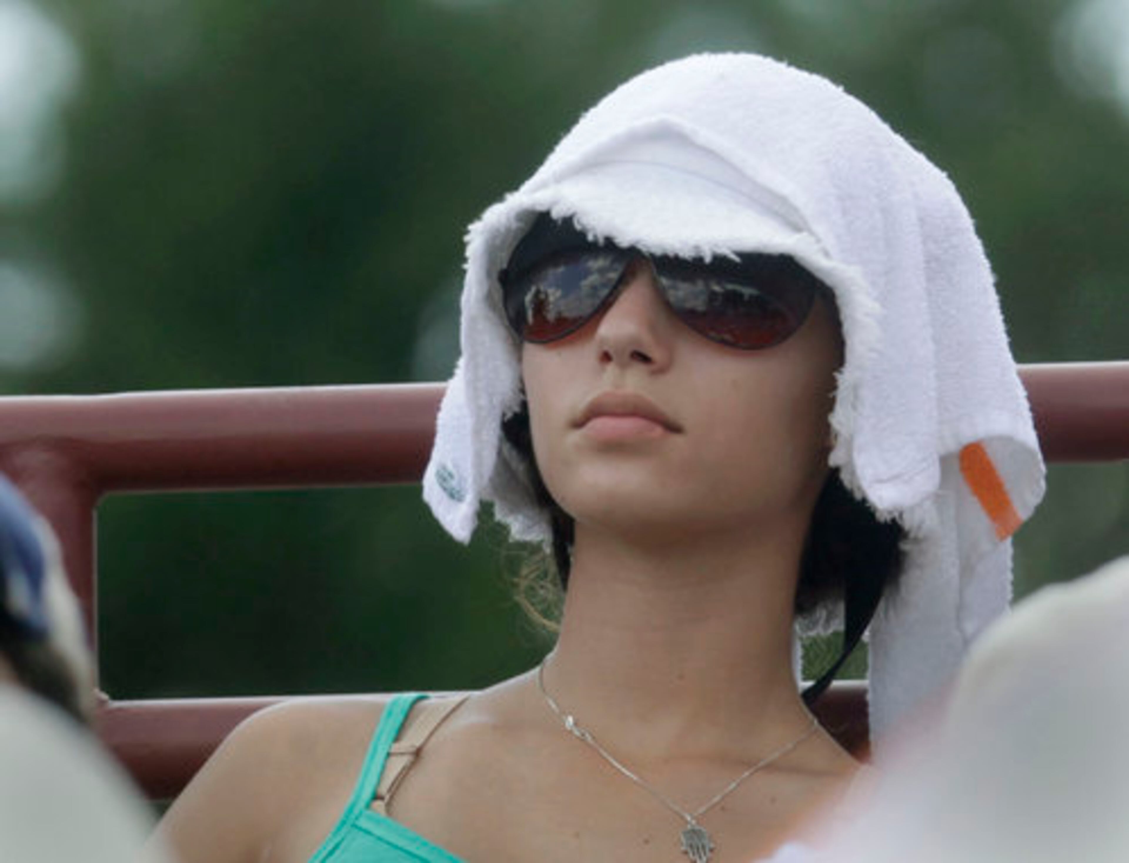 Spectators tried to keep cool any way they could, with umbrellas, towels, fans and water. Kenzie Gelernter tries to keep cool with a towel on her head. The Atlanta Tennis Championships finals in Johns Creek featured the team of Rohan Bopanna (IND) and Kristof Vliegen (BEL) against Scott Lipsky (USA) and Rajeev Ram (USA) in doubles and Mardy Fish vs John Isner in singles. Sun, July 25, 2010