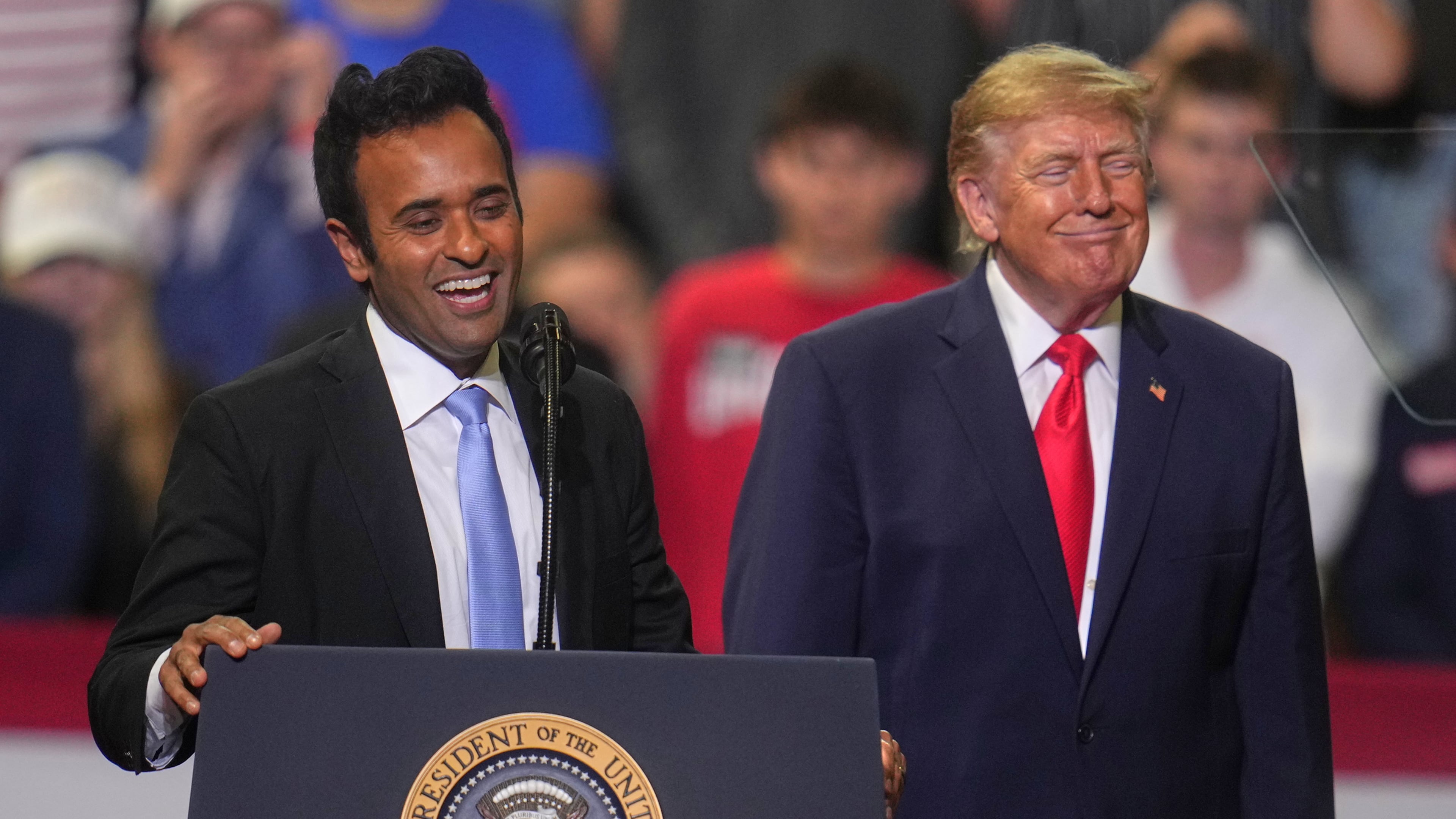 President Donald Trump listens a gubernatorial candidate Vivek Ramaswamy speaks at a campaign rally at the Covelli Centre, in Youngstown, Ohio, Monday, Oct. 12, 2026. (AP Photo/Gene J. Puskar)