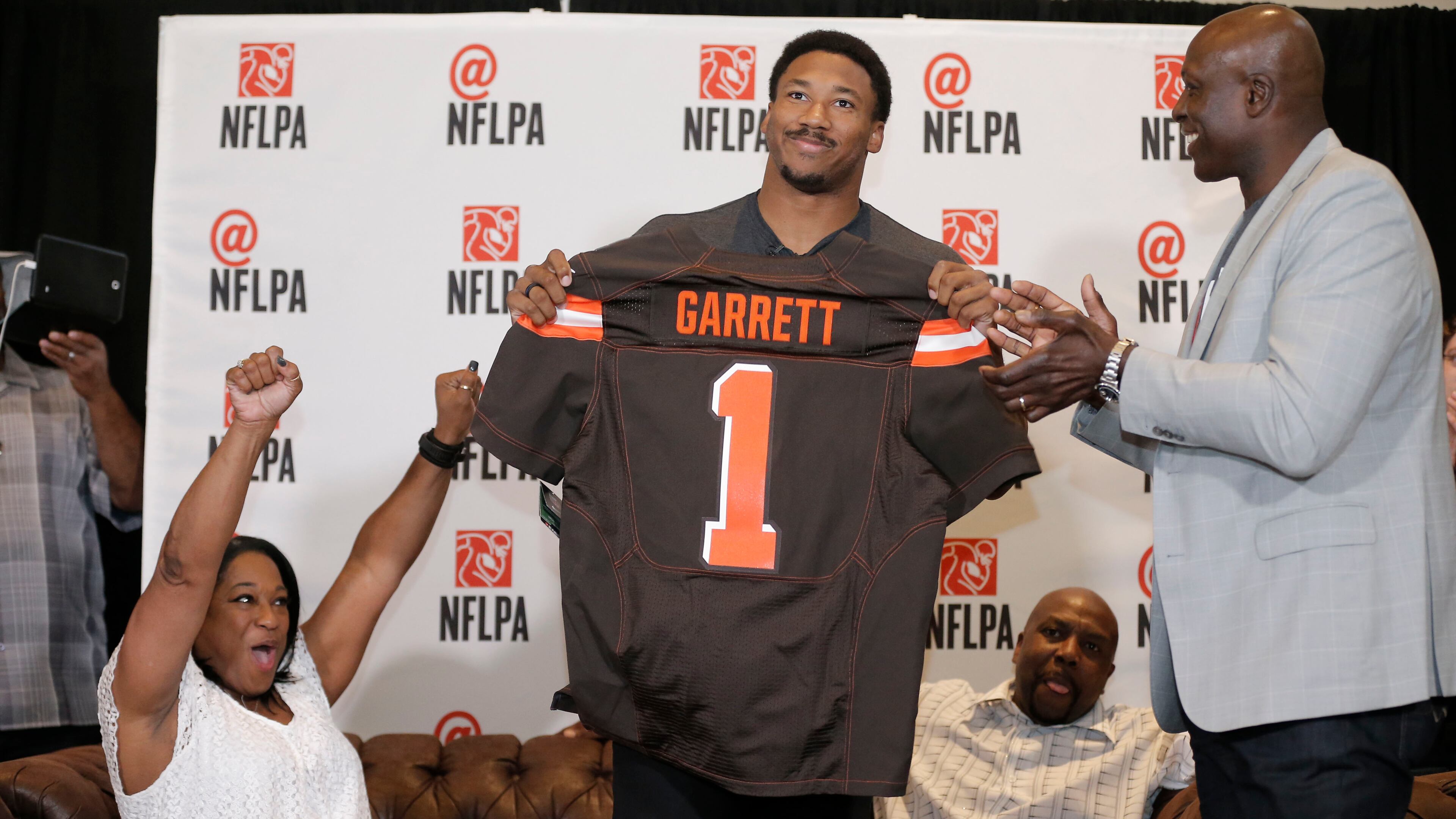 IMAGE DISTRIBUTED FOR FOR NFLPA - Former No. 1 overall pick Bruce Smith (right) presents a Cleveland Browns jersey to Myles Garrett while his mother Audrey (left) and father Lawrence look on at the NFL Players Association's Myles Garrett Draft Day party at Terra Verde on Thursday, April 27, 2017, in Arlington, Texas. (Brandon Wade/AP Images for NFLPA)