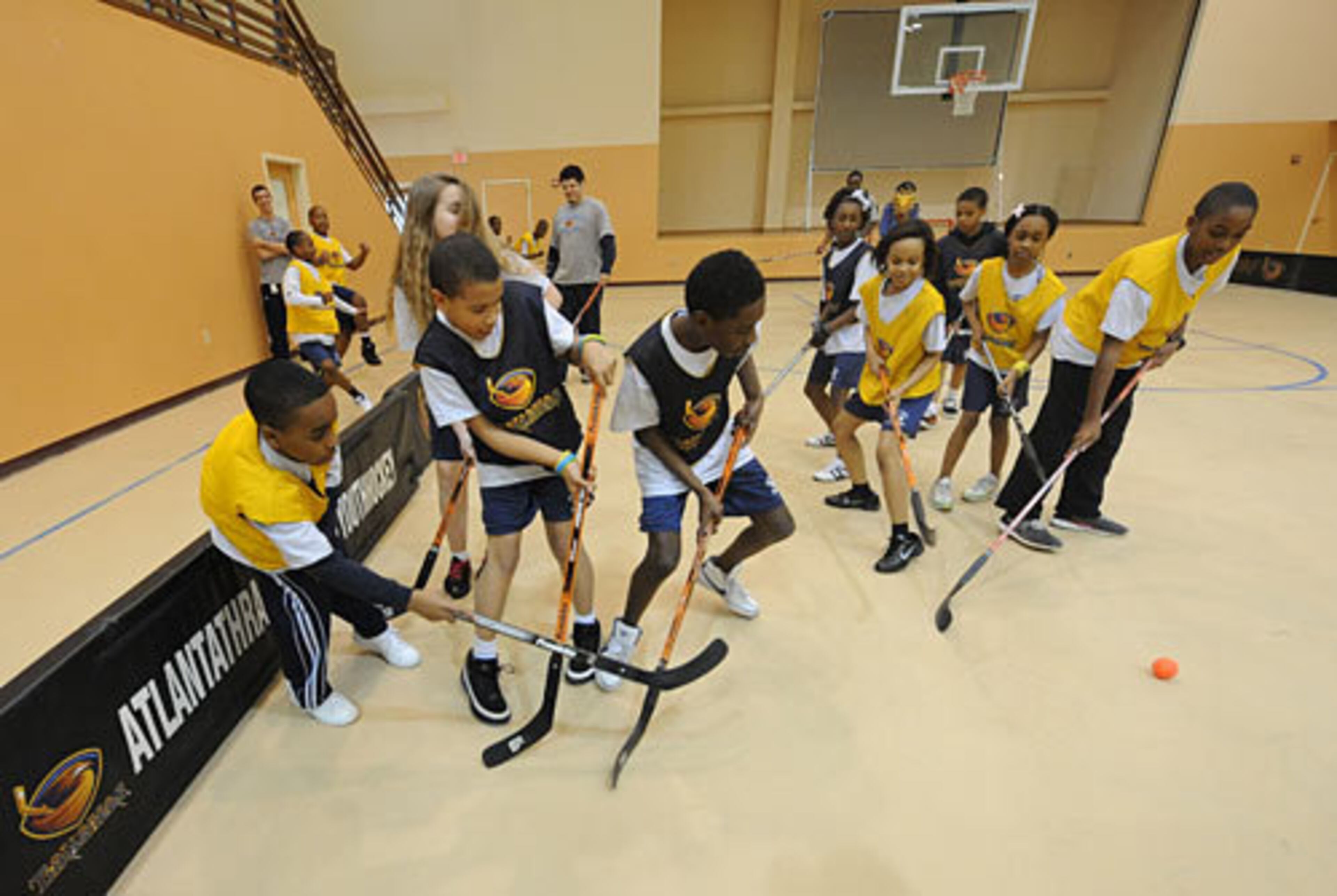 Students try to control the ball during the hockey clinic as they work on skills.