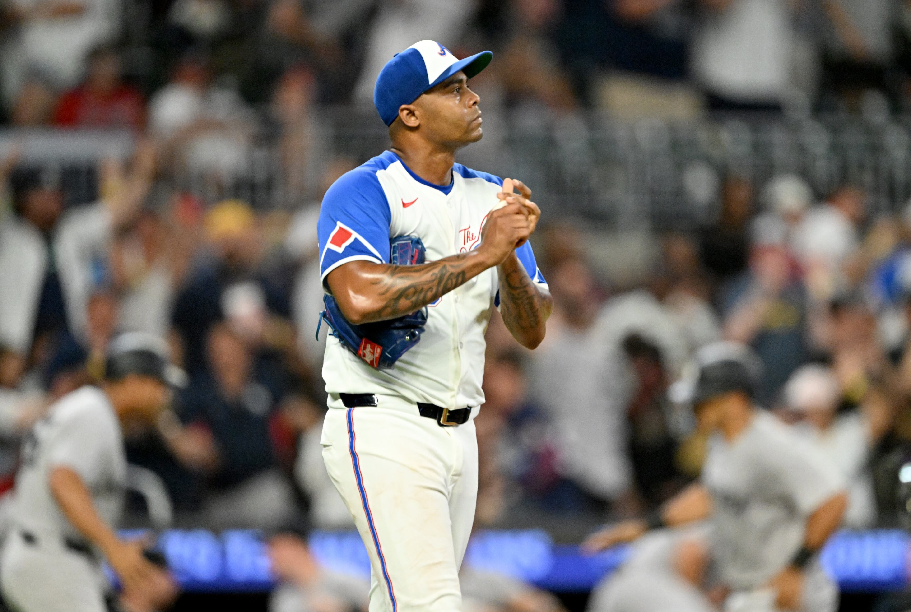 Atlanta Braves pitcher Raisel Iglesias (26) reacts after allowing a grand slam by New York Yankees outfielder Trent Grisham (12) during the ninth inning of a baseball game at Truist Park, Saturday, July 19, 2025, in Atlanta. New York Yankees won 12-9 over Atlanta Braves. (Hyosub Shin / AJC)