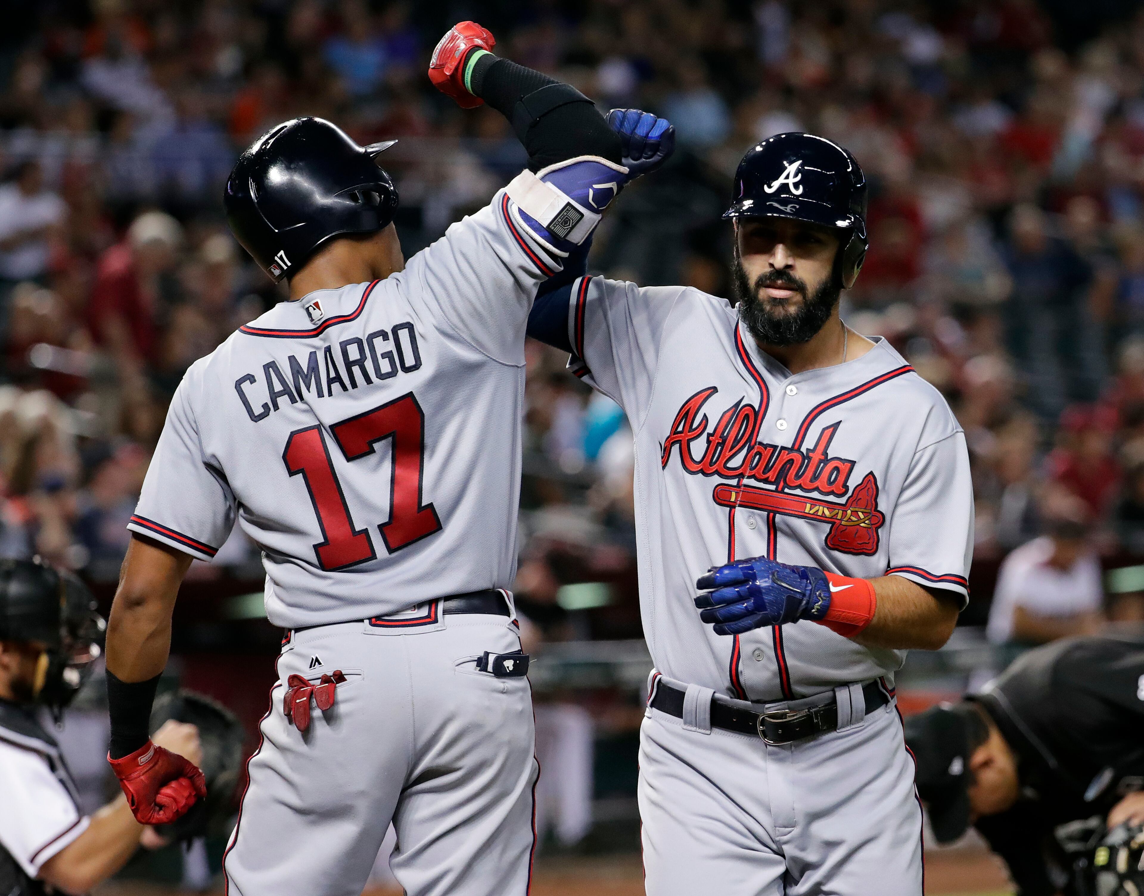 Atlanta Braves' Sean Rodriguez greets teammate Johan Camargo (17) after hitting a two run home run against the Arizona Diamondbacks during the fifth inning of a baseball game, Monday, July 24, 2017, in Phoenix. (AP Photo/Matt York)