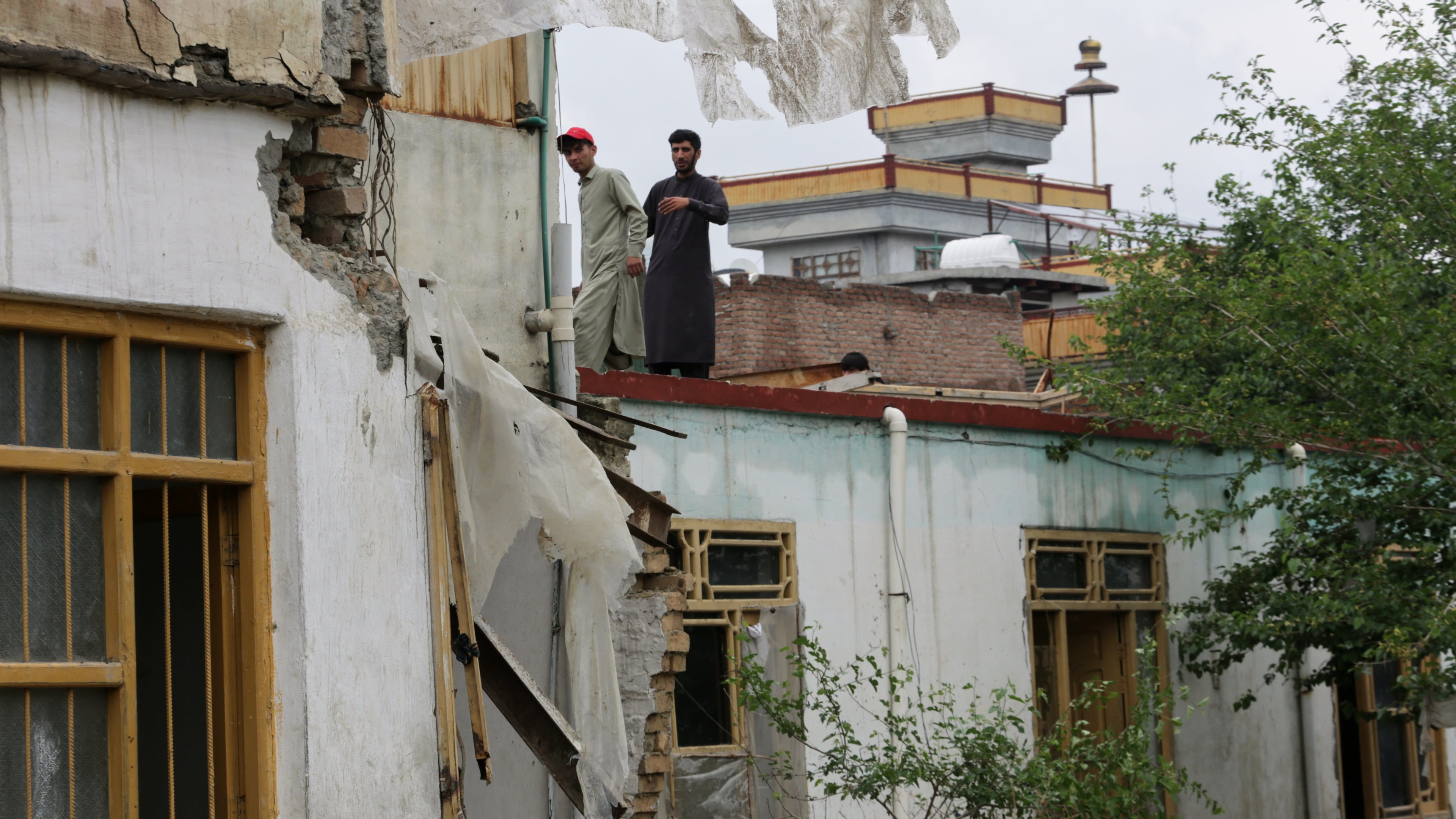 Residents inspect a building damaged by heavy flooding in Jalalabad, Afghanistan, Saturday, April 4, 2026. (AP Photo/Wahidullah Kakar)