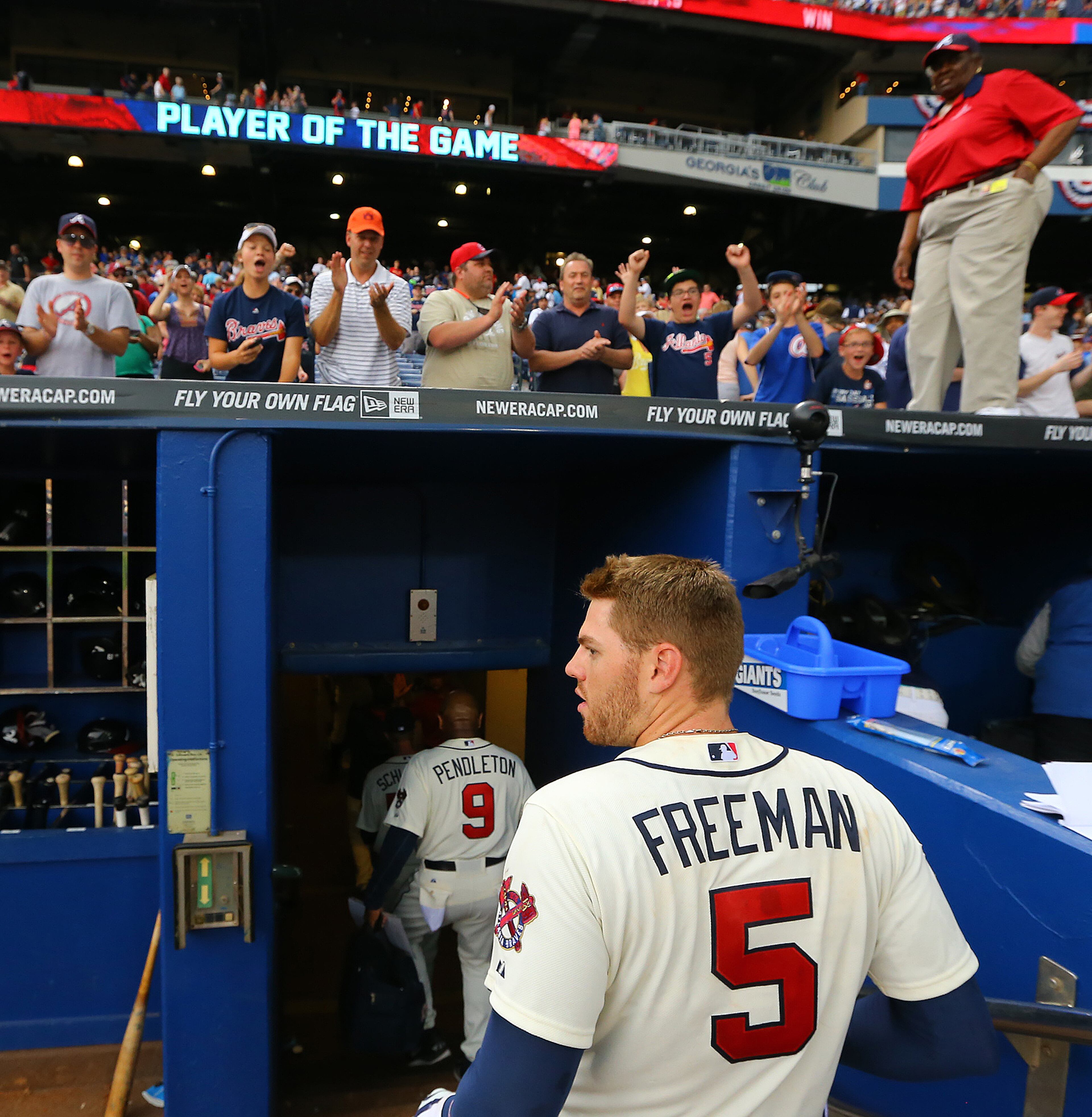 Braves fans applaud the player of the game, Freddie Freeman, as he leaves the field after hitting a game- winning RBI single to beat the Reds 1-0 in the 10th inning. CURTIS COMPTON / CCOMPTON@AJC.COM